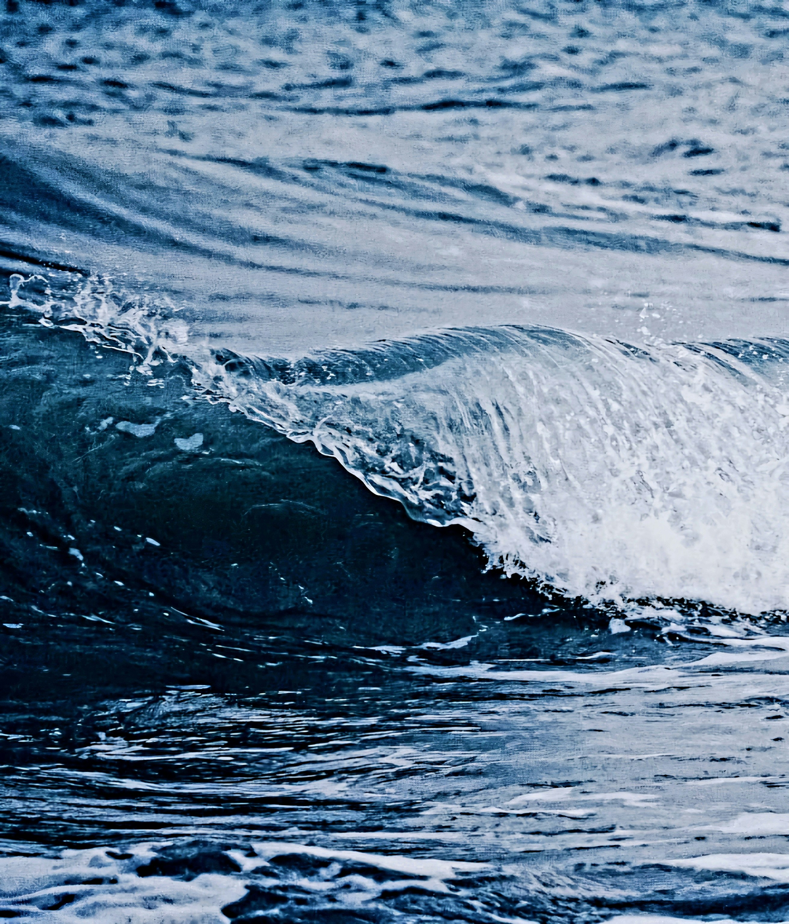 Dark blue offshore swell with white foam crests