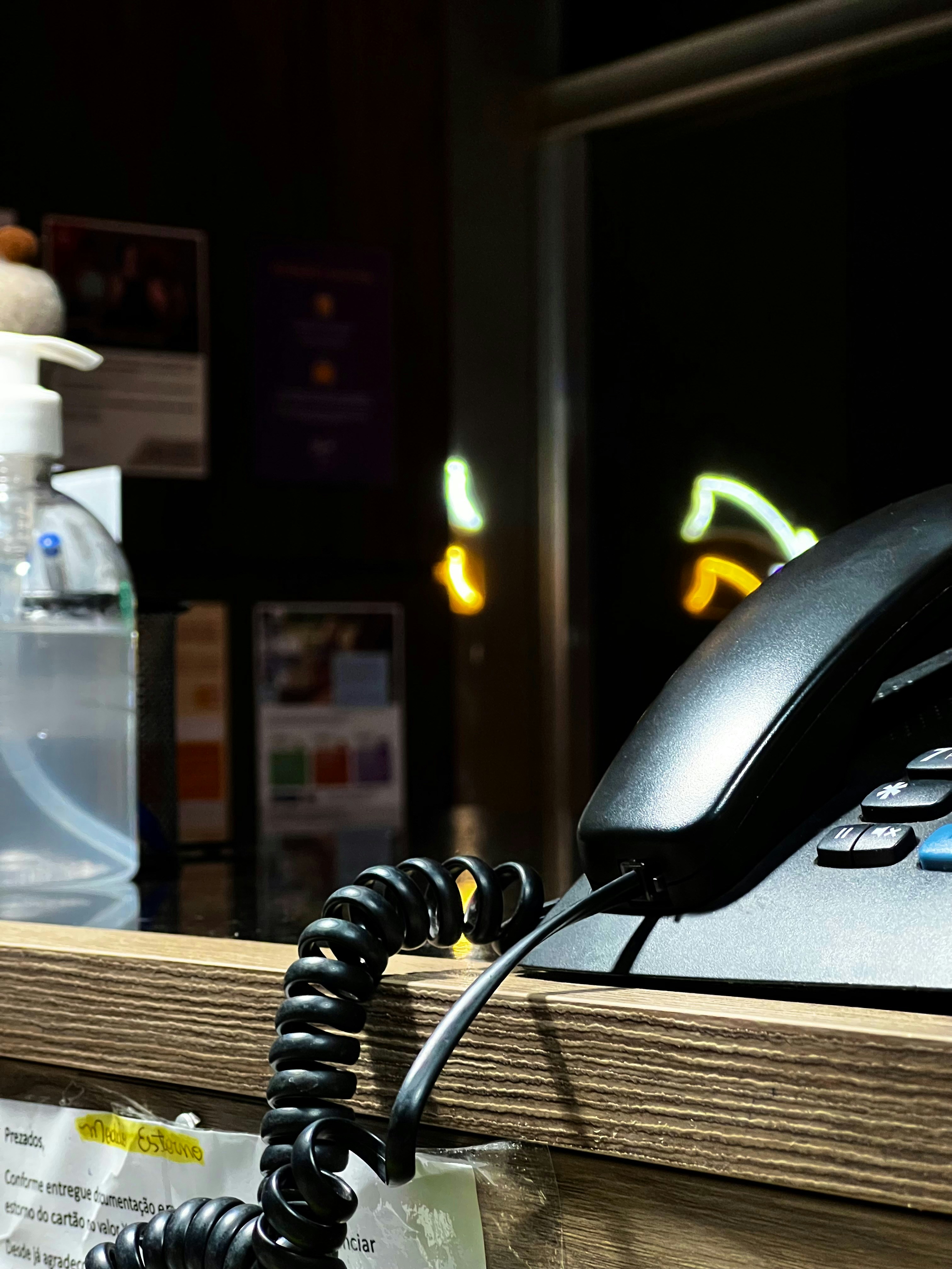 A phone is plugged into a cord on a desk