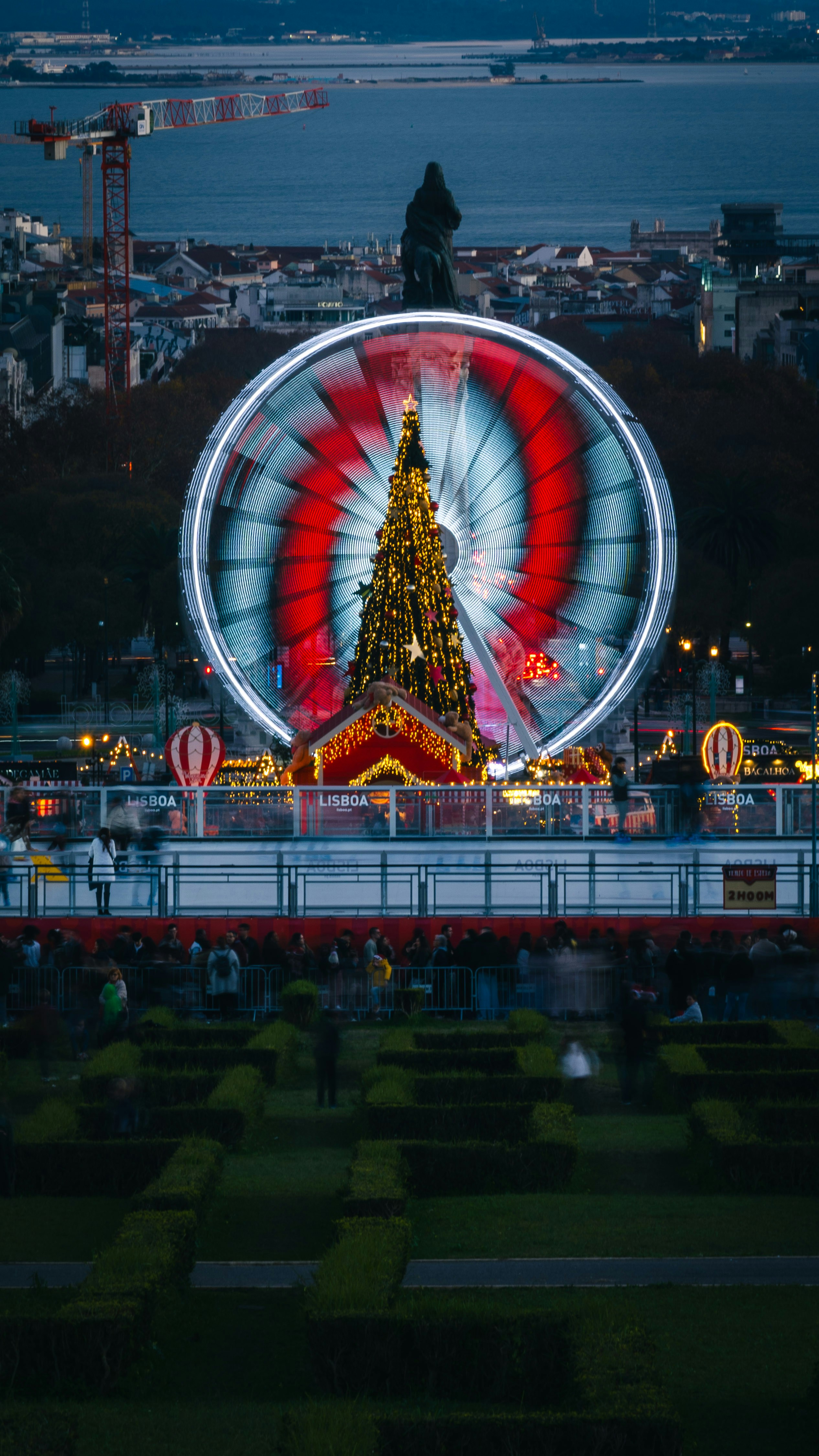 A ferris wheel with a christmas tree on top of it