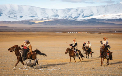 A group of people riding on the backs of horses