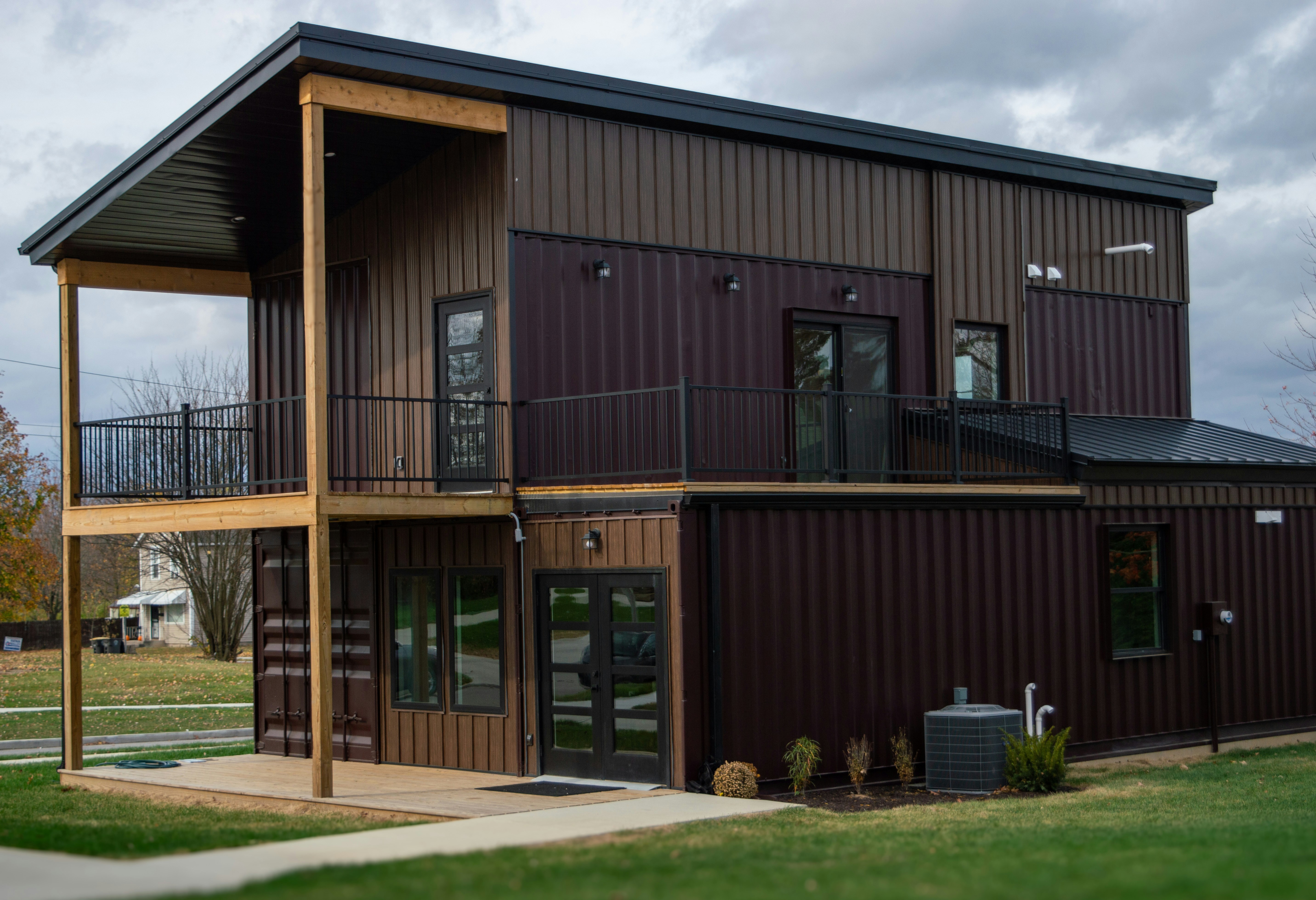 A large brown building sitting on top of a lush green field
