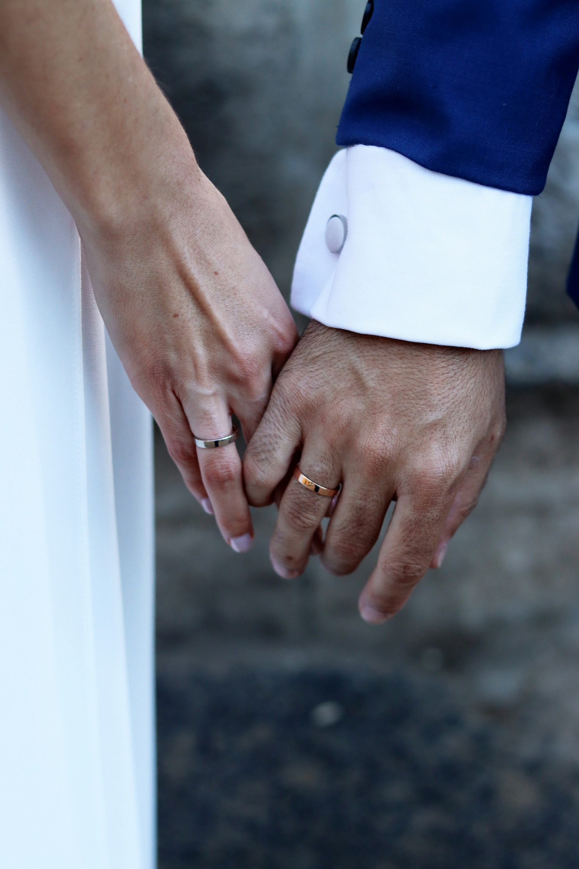 A close up of two people holding hands