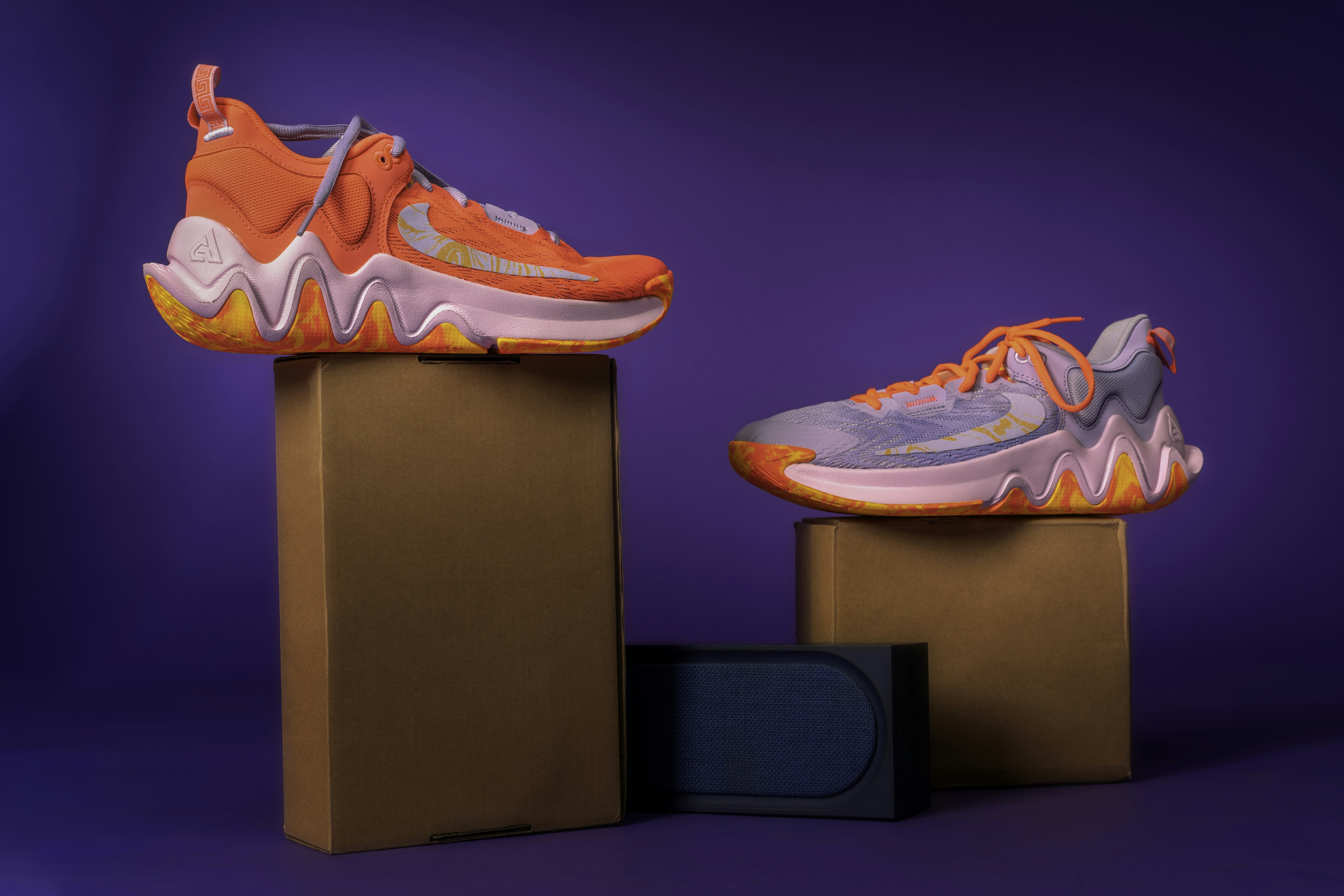 A bold and vibrant pair of Nike sneakers featuring dynamic orange, pink, and yellow accents, designed for style and performance.