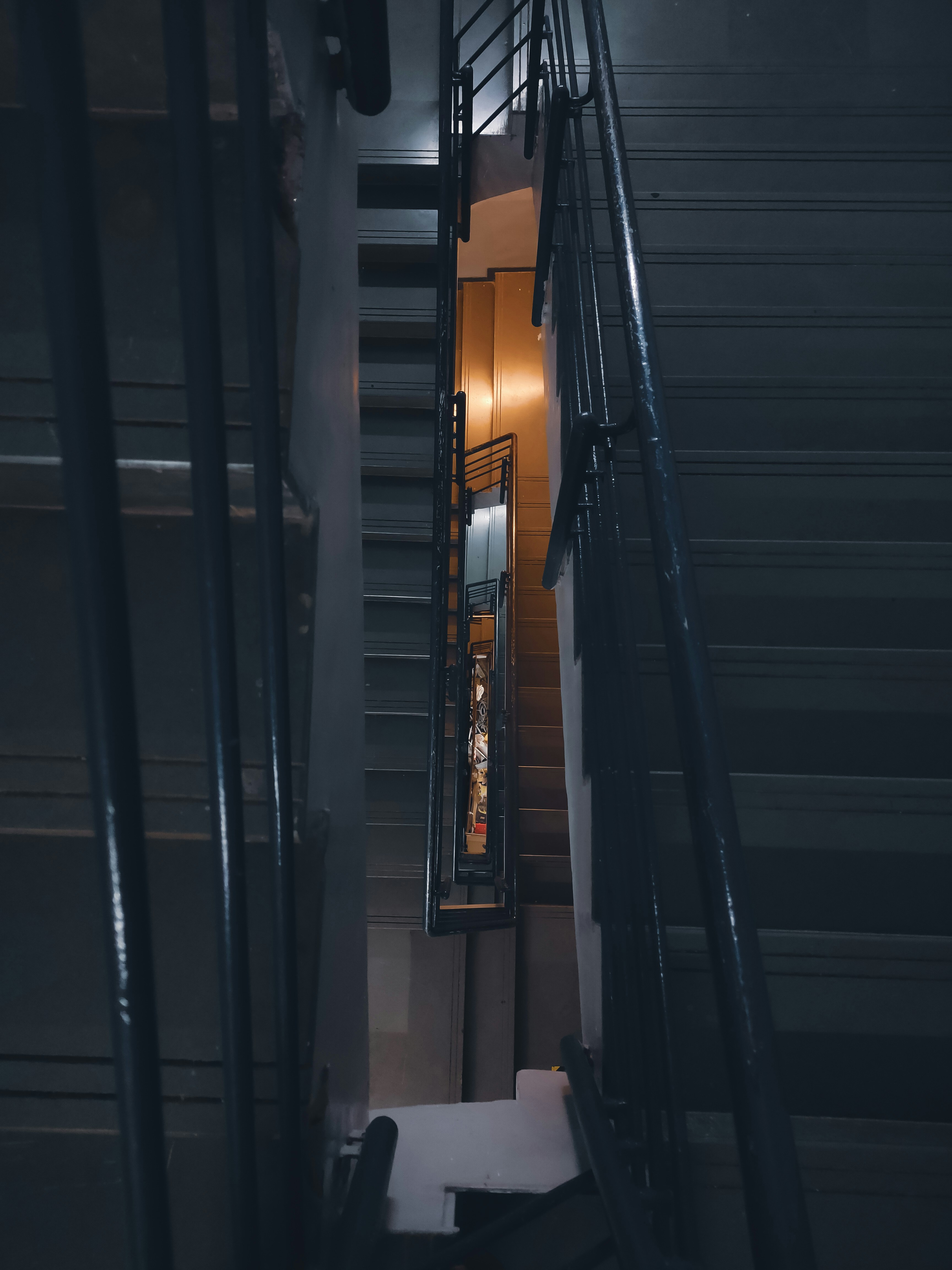 A stairway with a light at the end of it