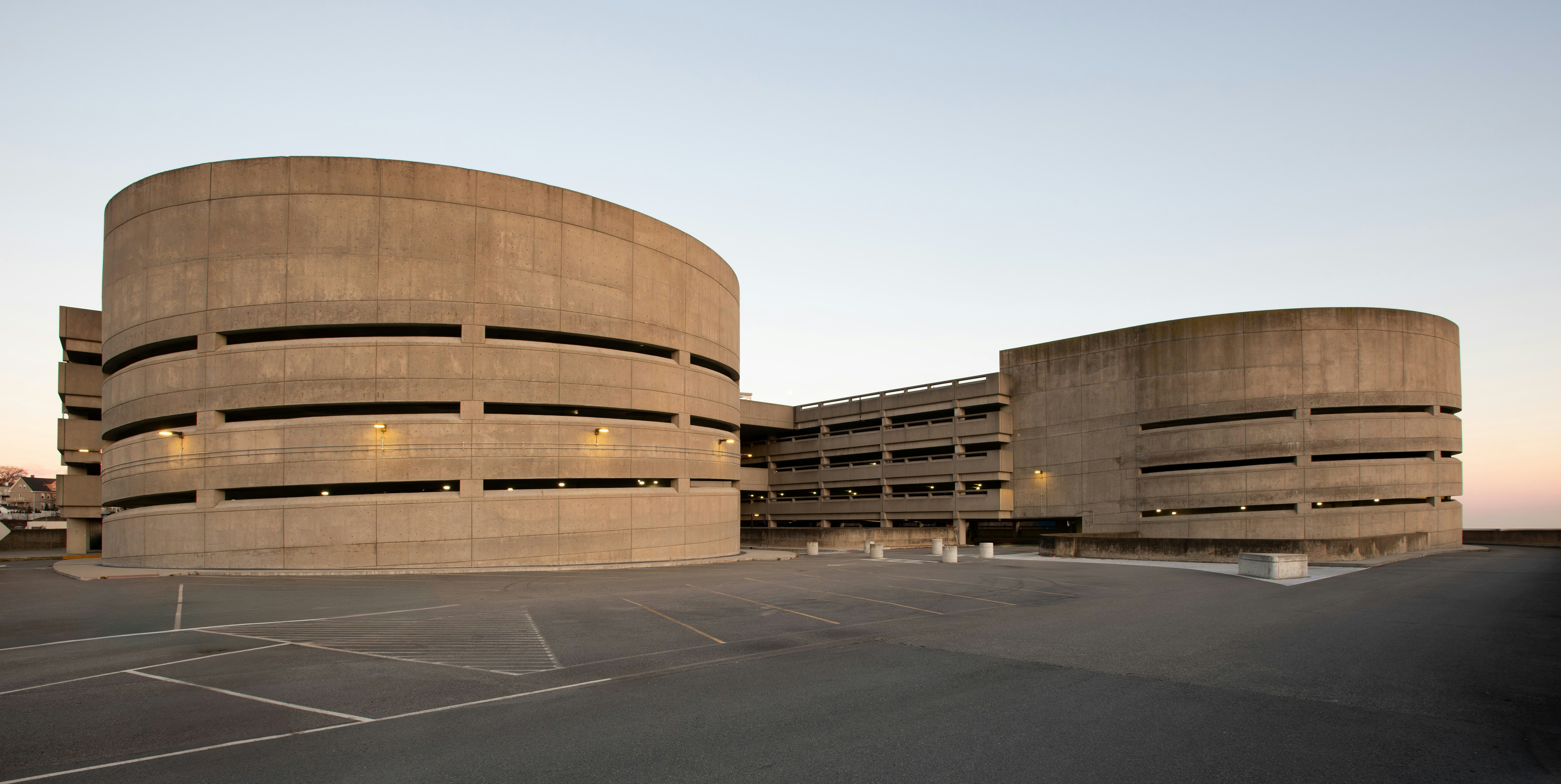 A parking lot with a building in the background