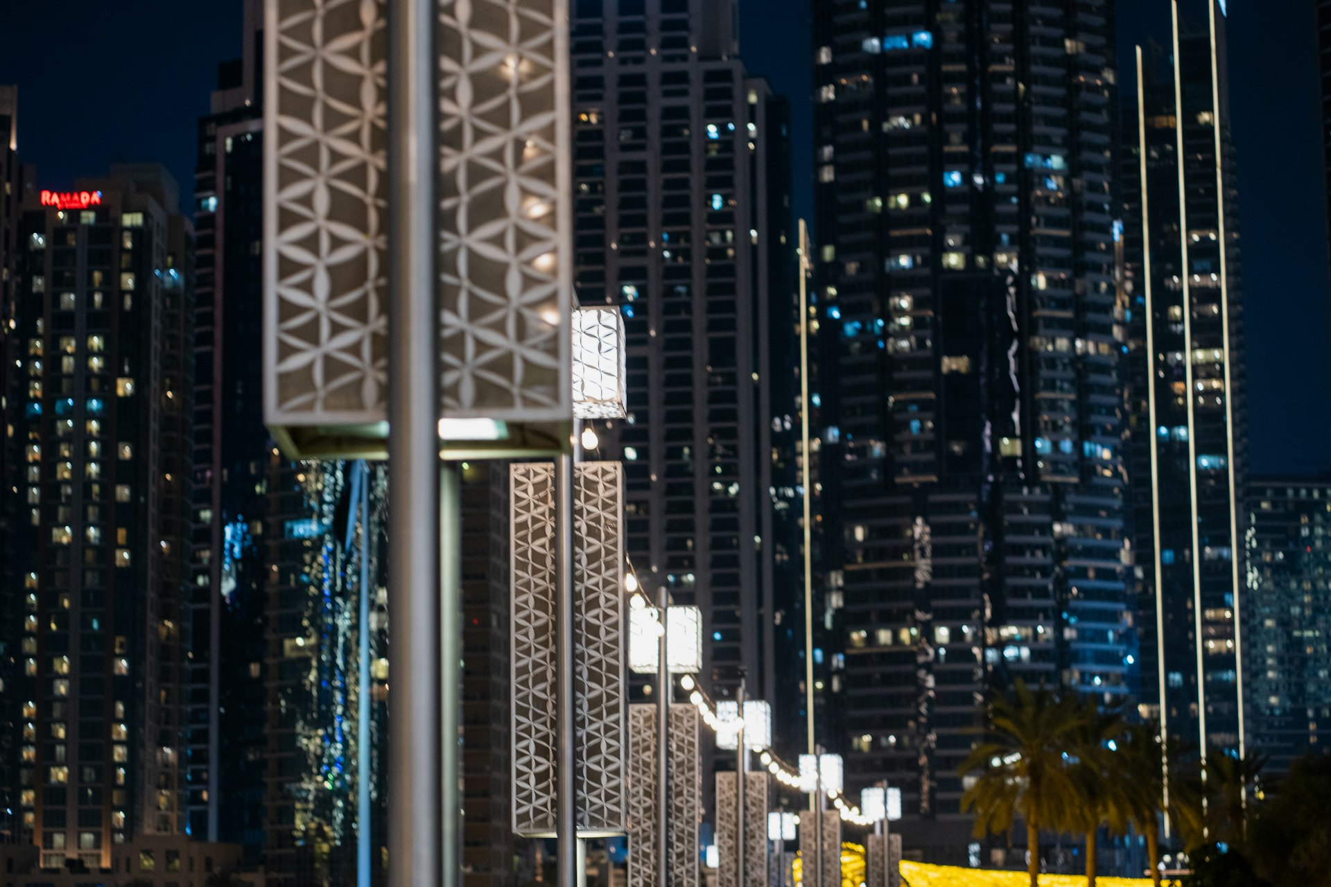 A city skyline at night with a clock tower in the foreground