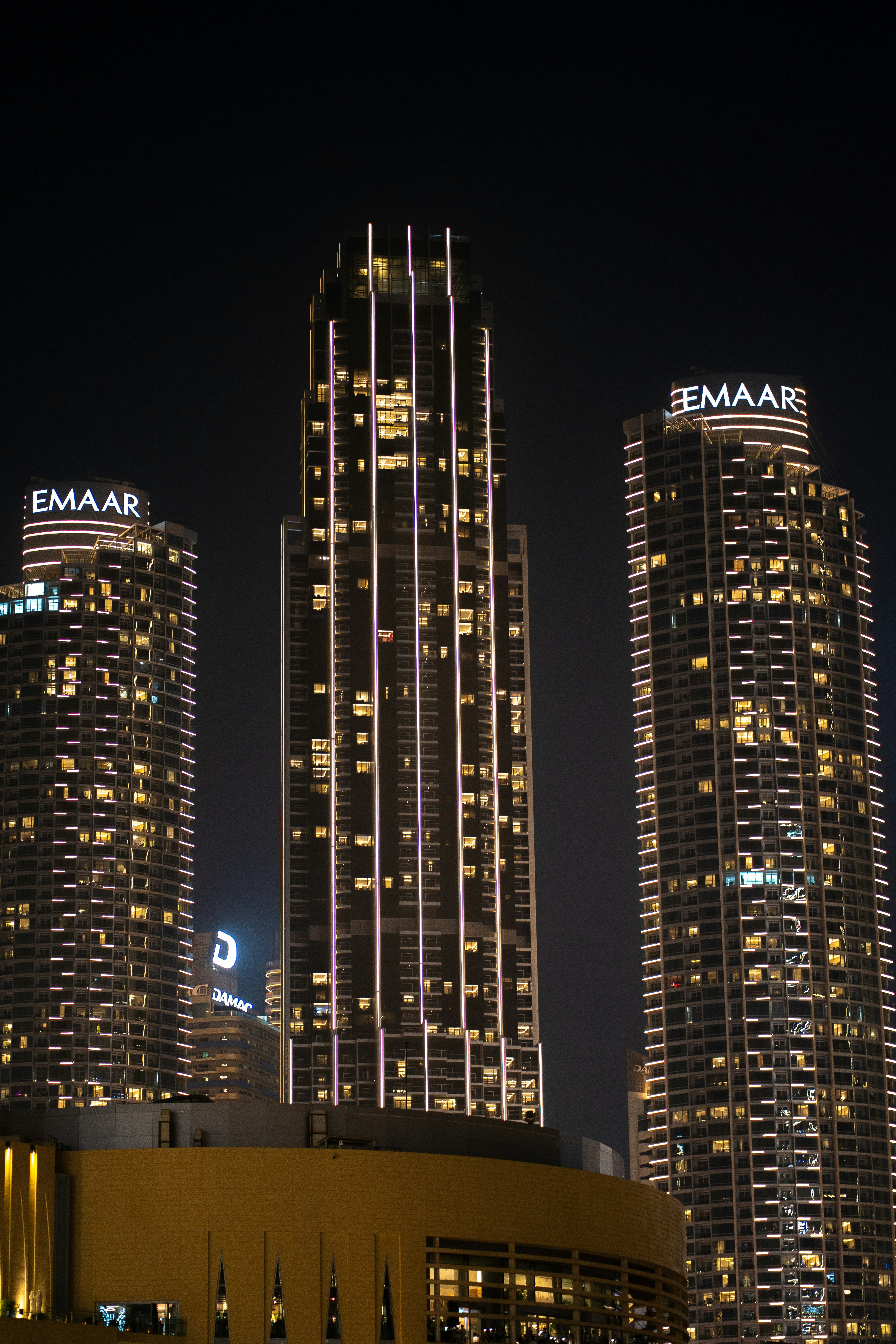 A city at night with tall buildings lit up