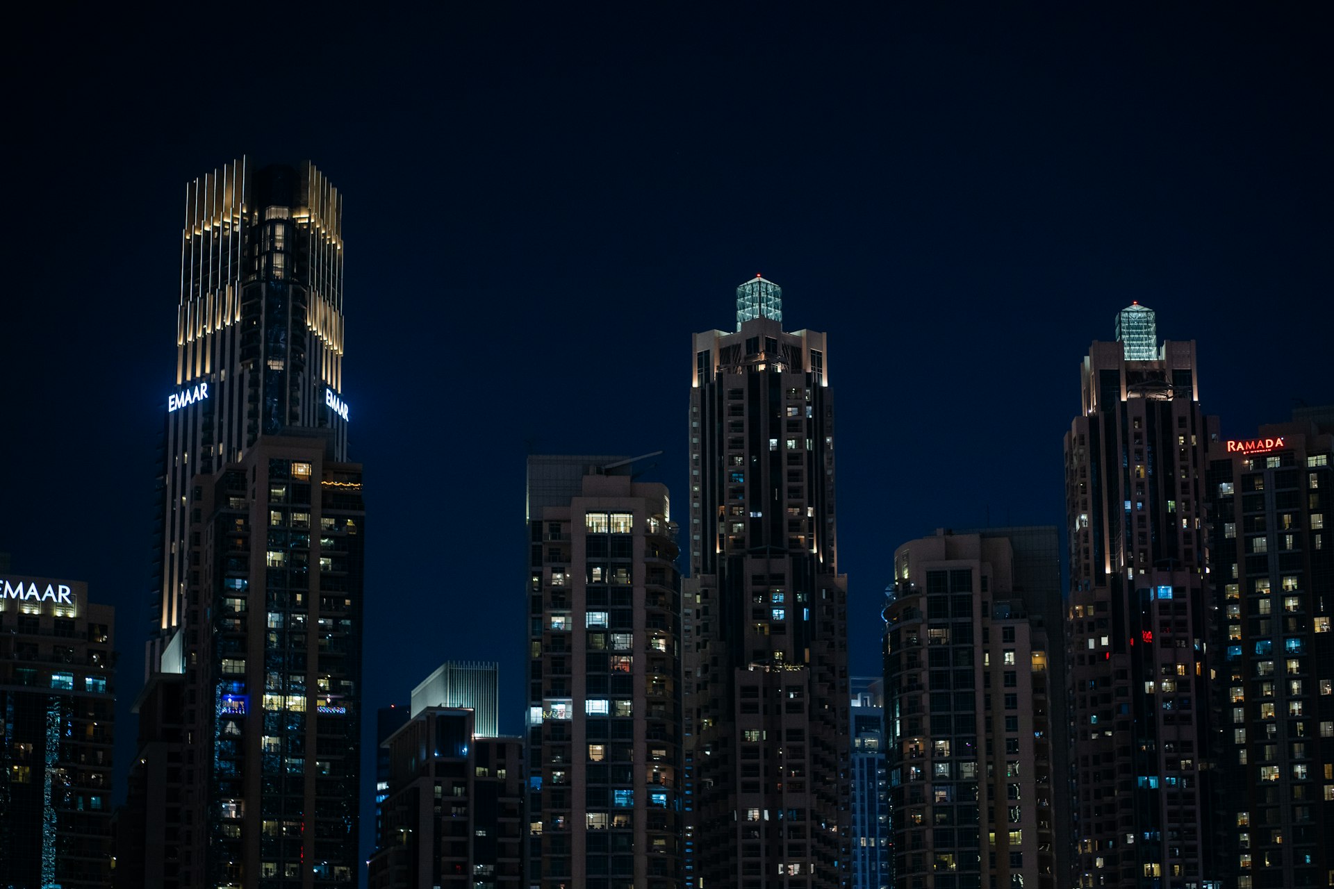 A city at night with a boat in the water
