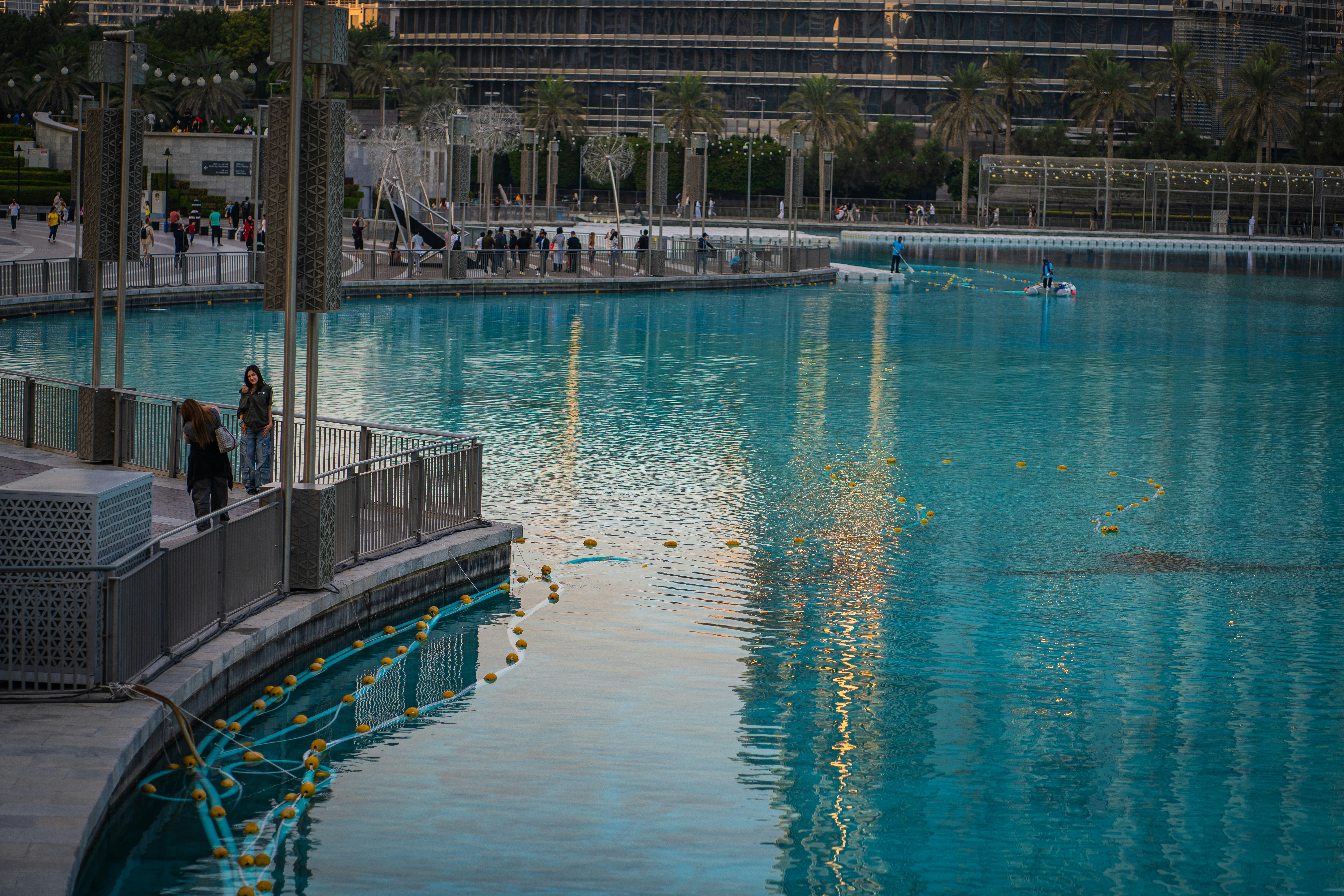 A large swimming pool in a city with buildings in the background