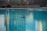 A person in a small boat in a large body of water
