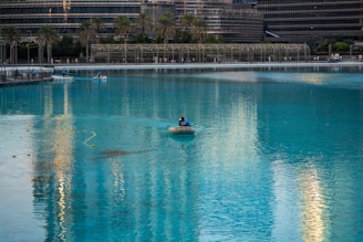 A person in a small boat in a large body of water