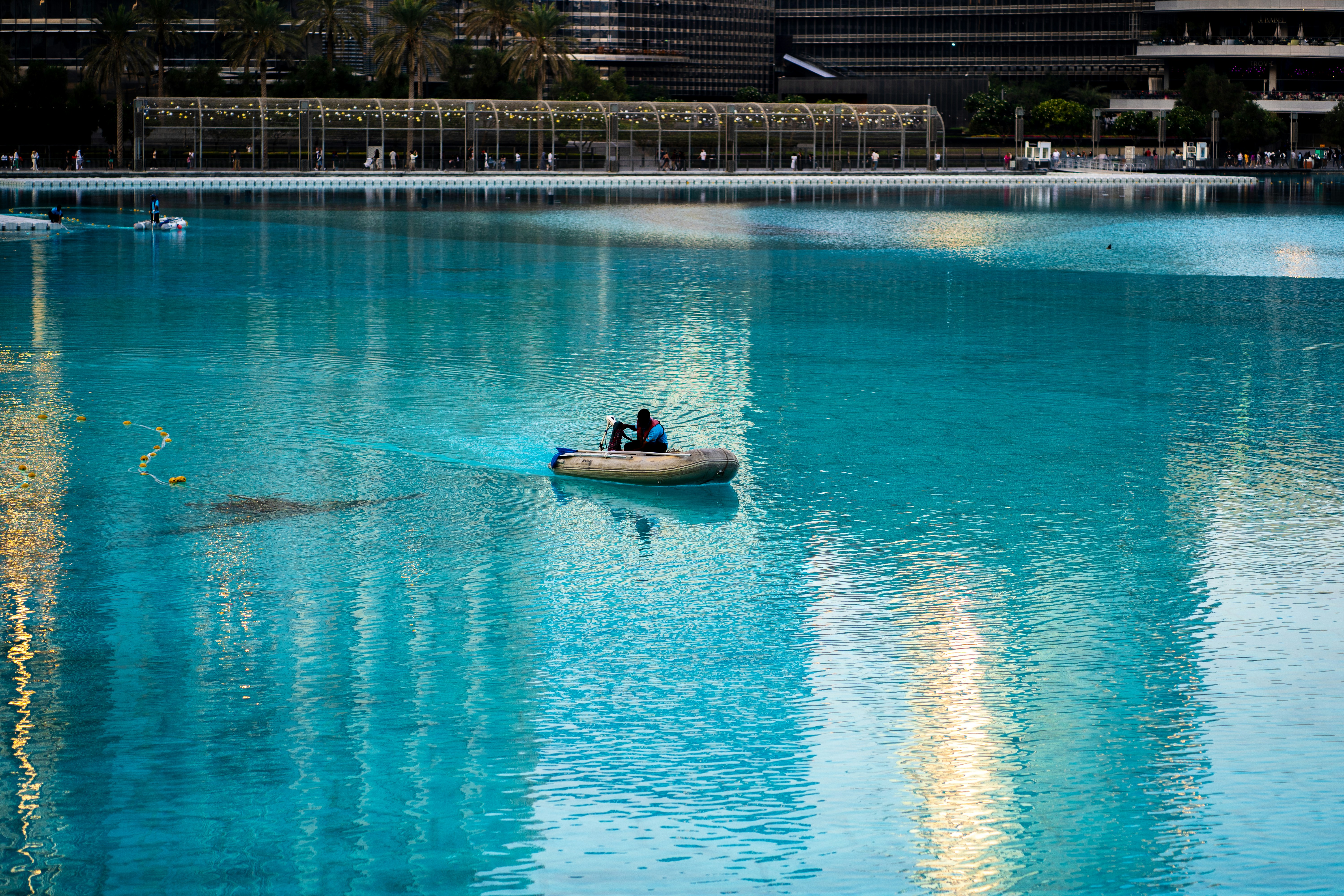 A small boat floating on top of a lake