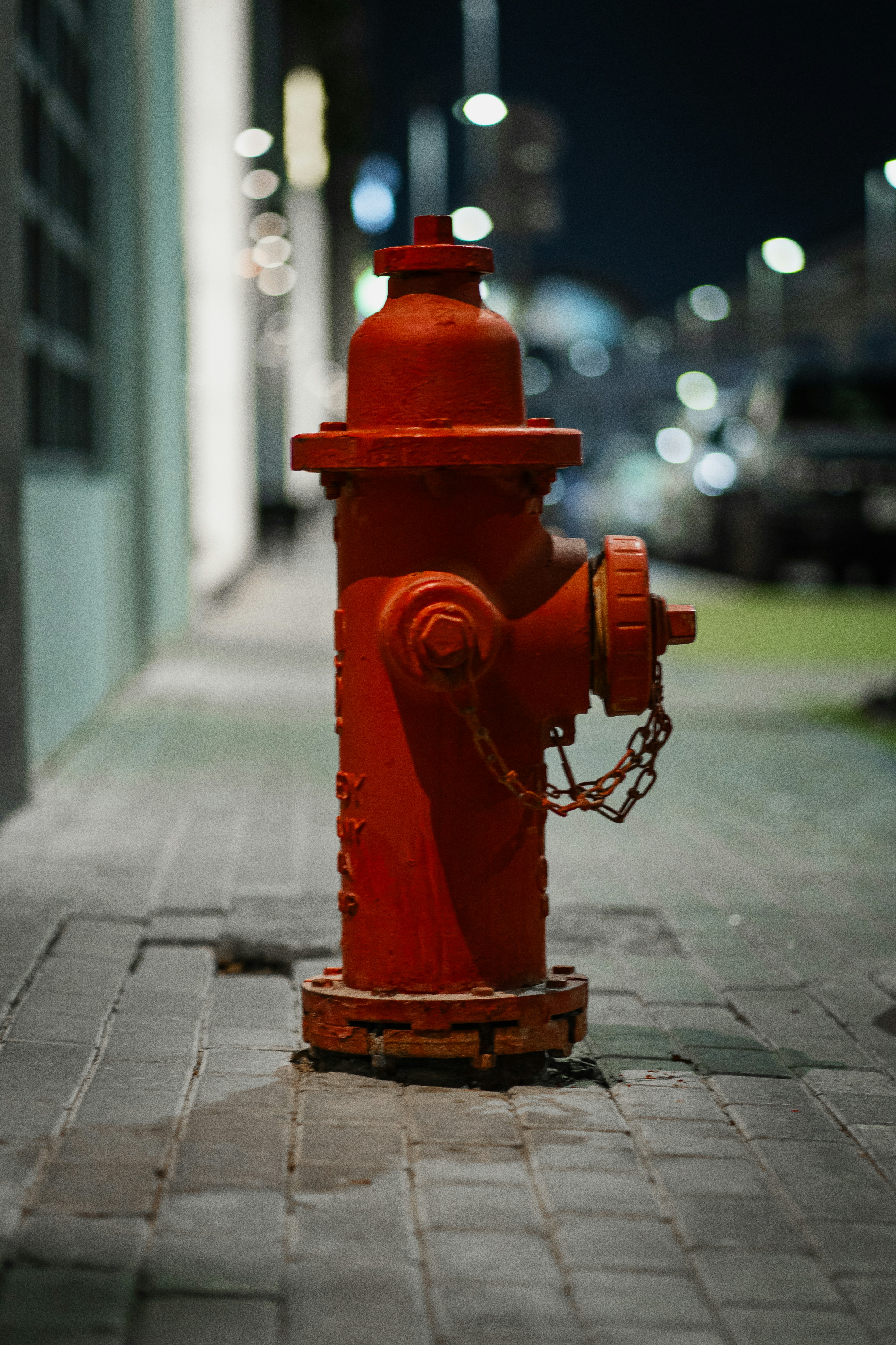 A red fire hydrant sitting on the side of a road