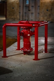 A red fire hydrant sitting on the side of a road