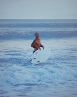 A man holding a surfboard in the ocean
