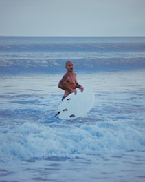 A man holding a surfboard in the ocean