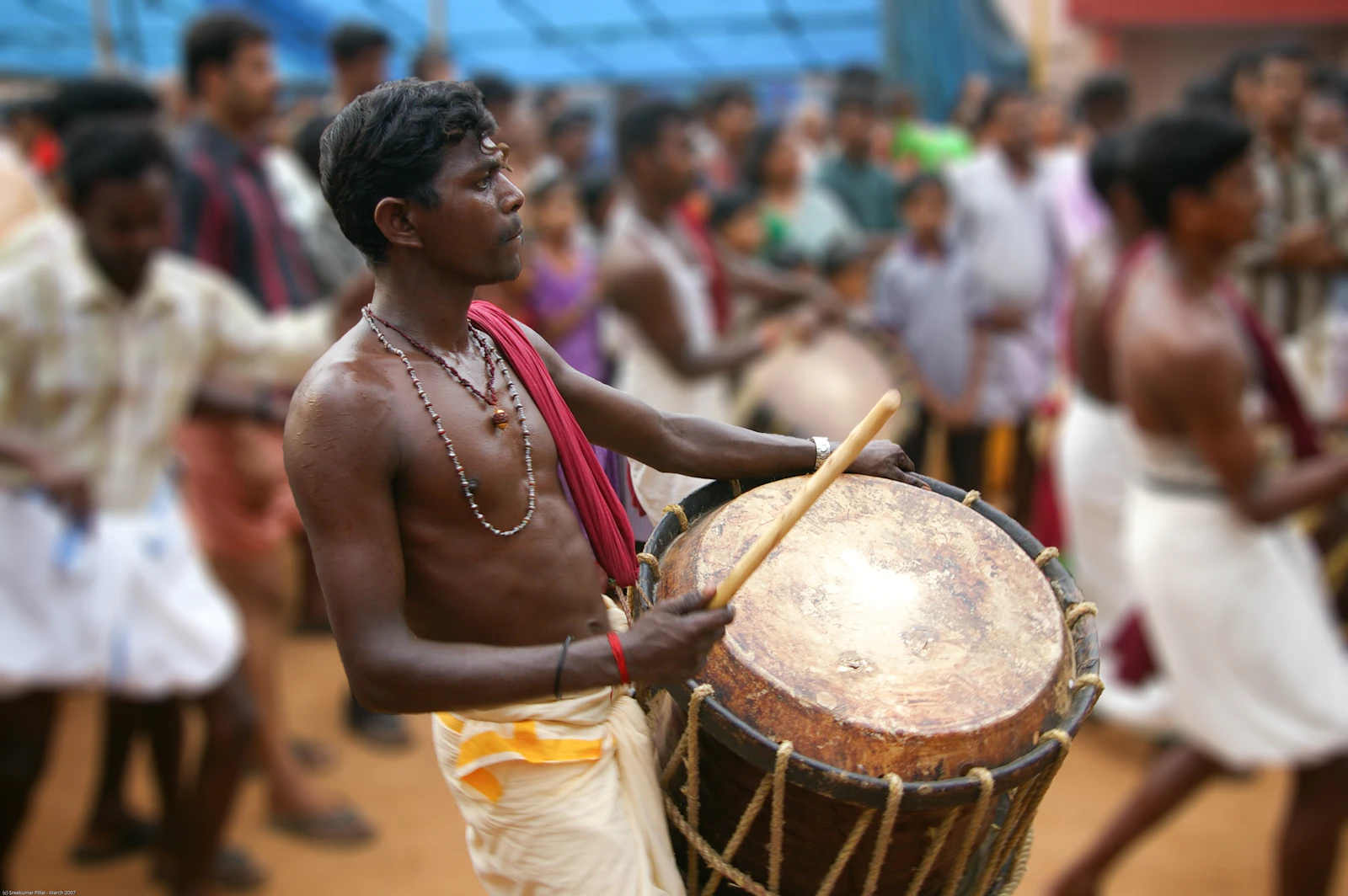 A chenda player commands the crowd — the sound that announces Kerala anywhere in the world.
