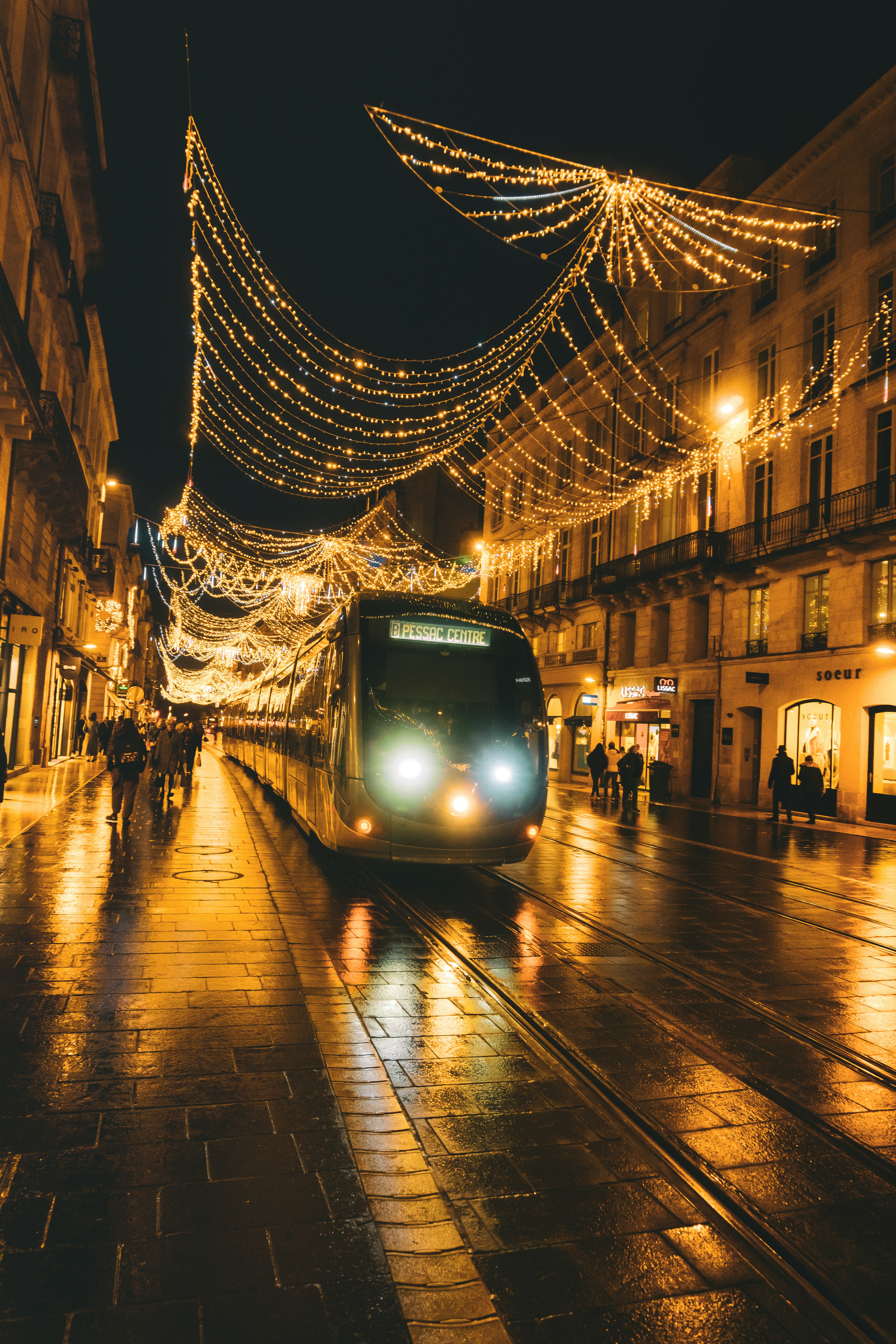 A train traveling down a city street at night