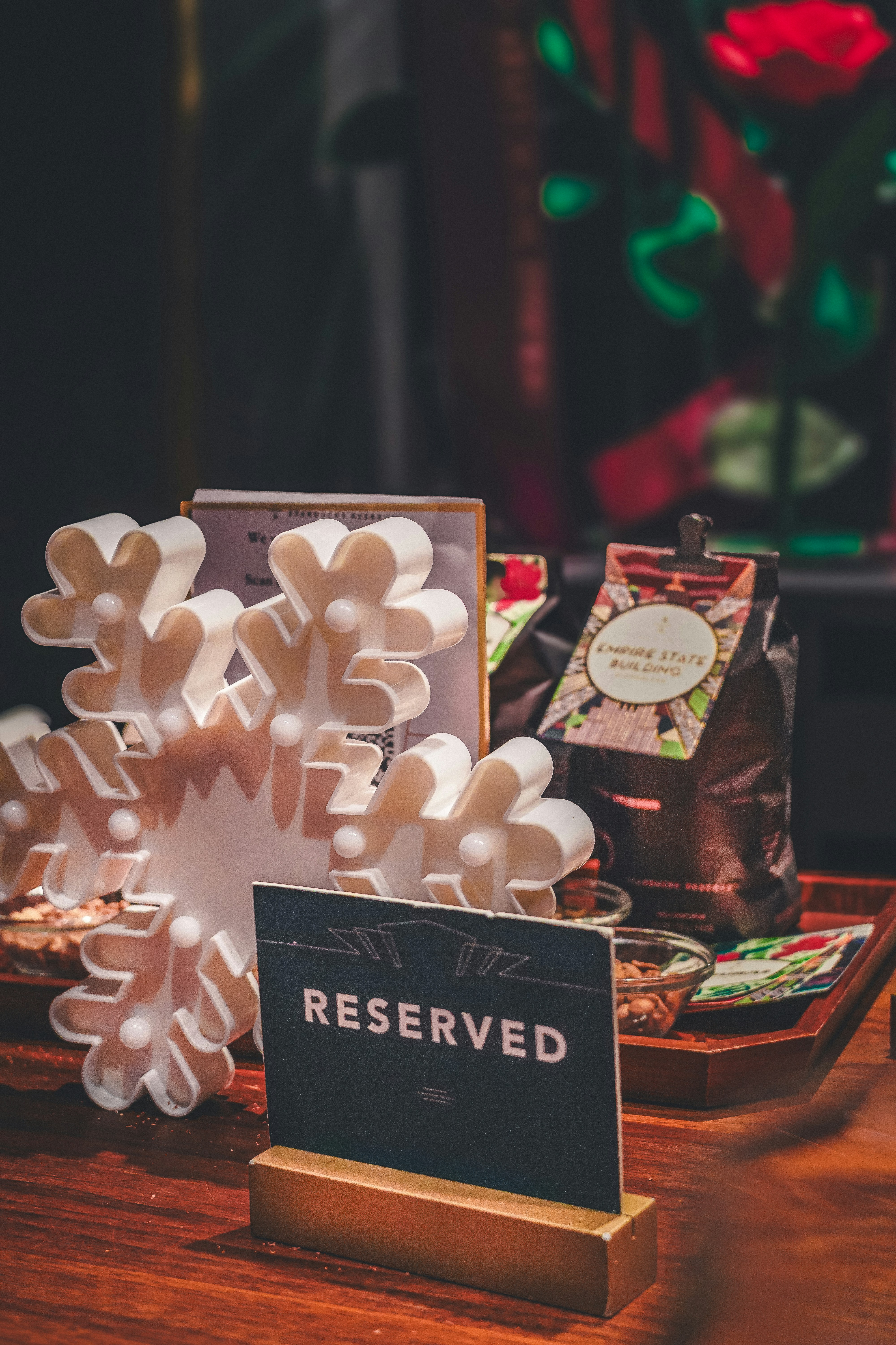 A wooden table topped with a snowflake next to a sign