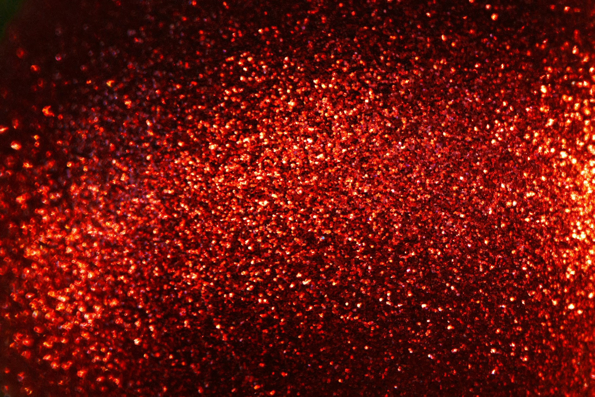 A close up of a red glitter ball
