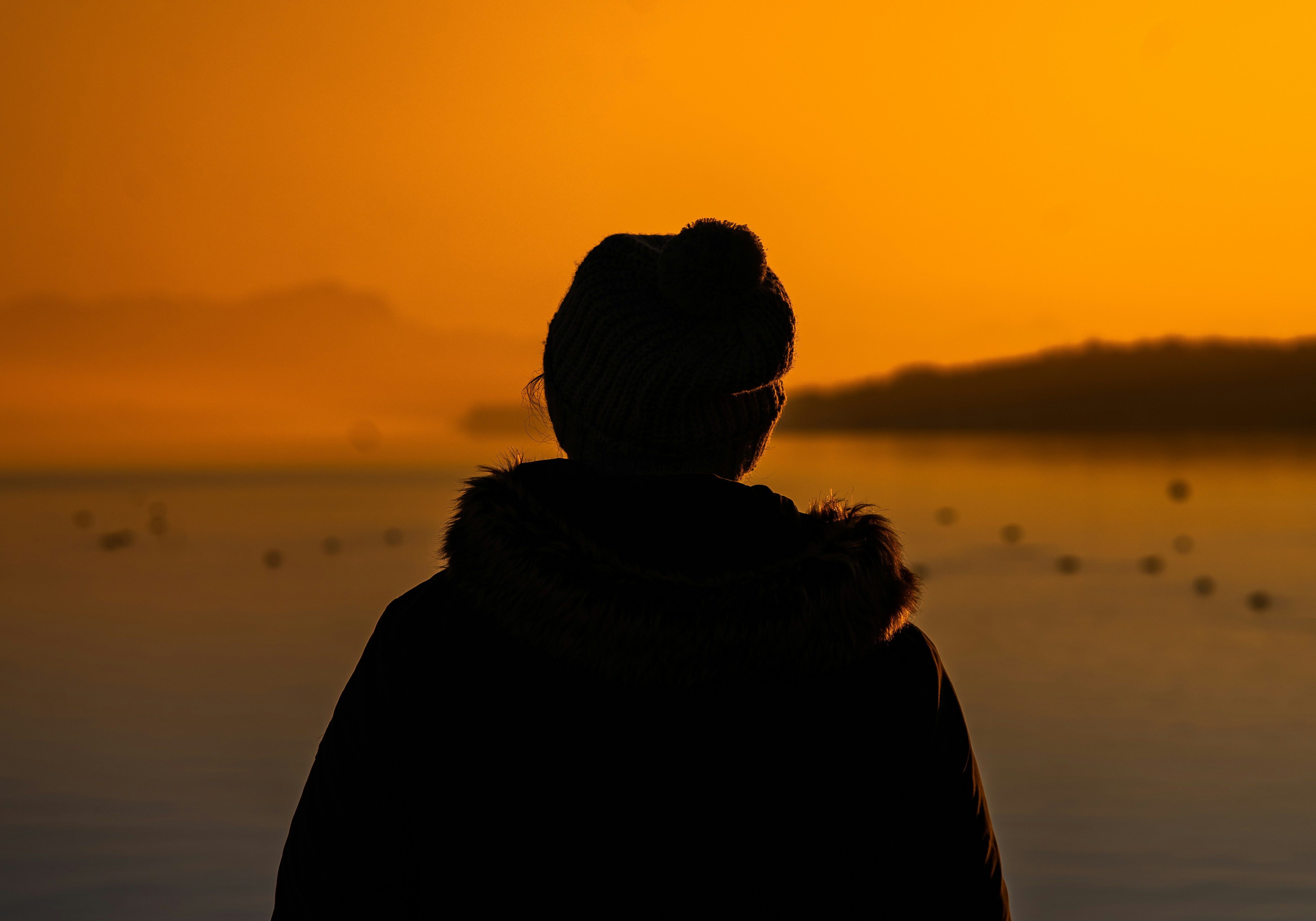 A person standing in front of a body of water