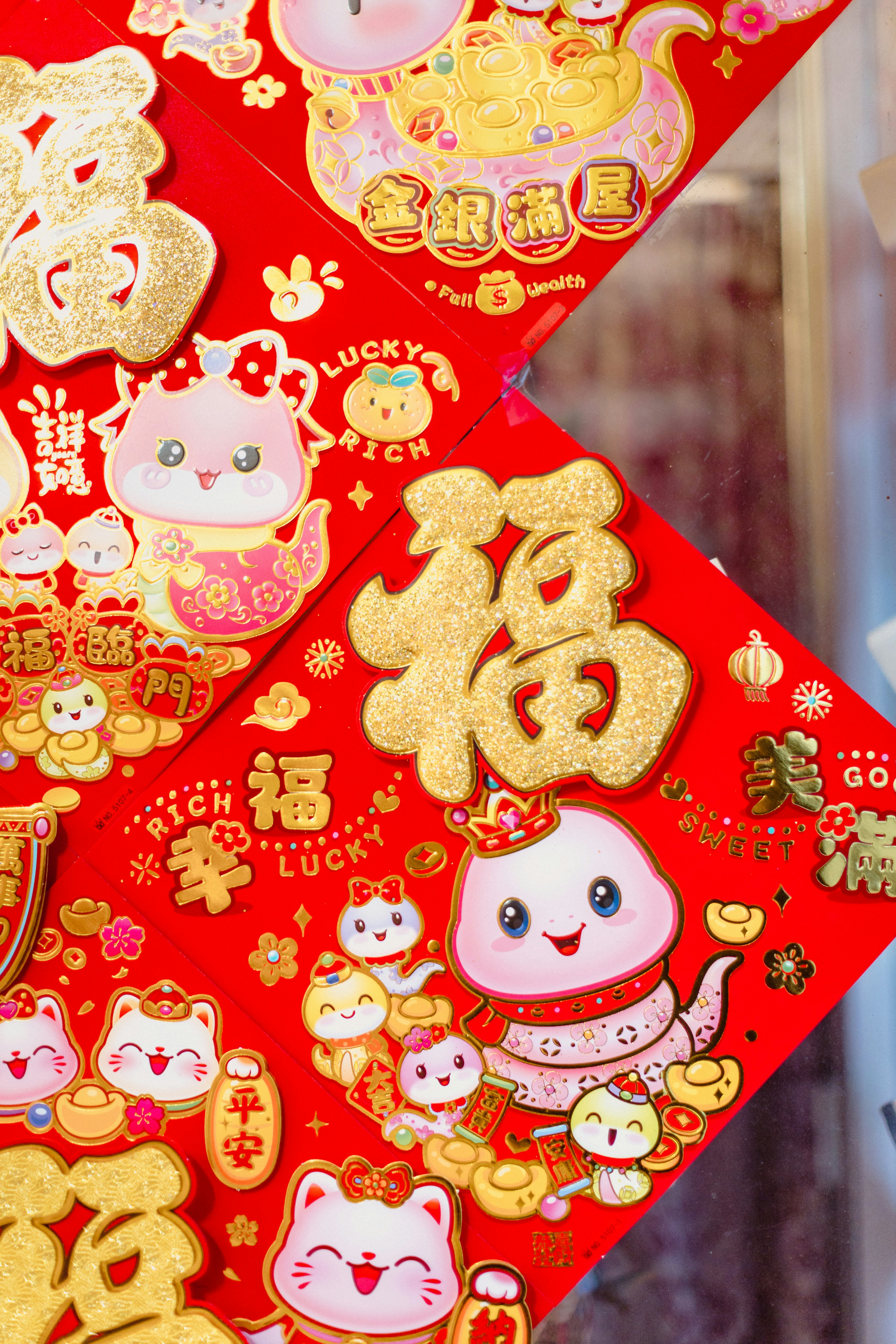 A close up of a red paper with gold decorations on it
