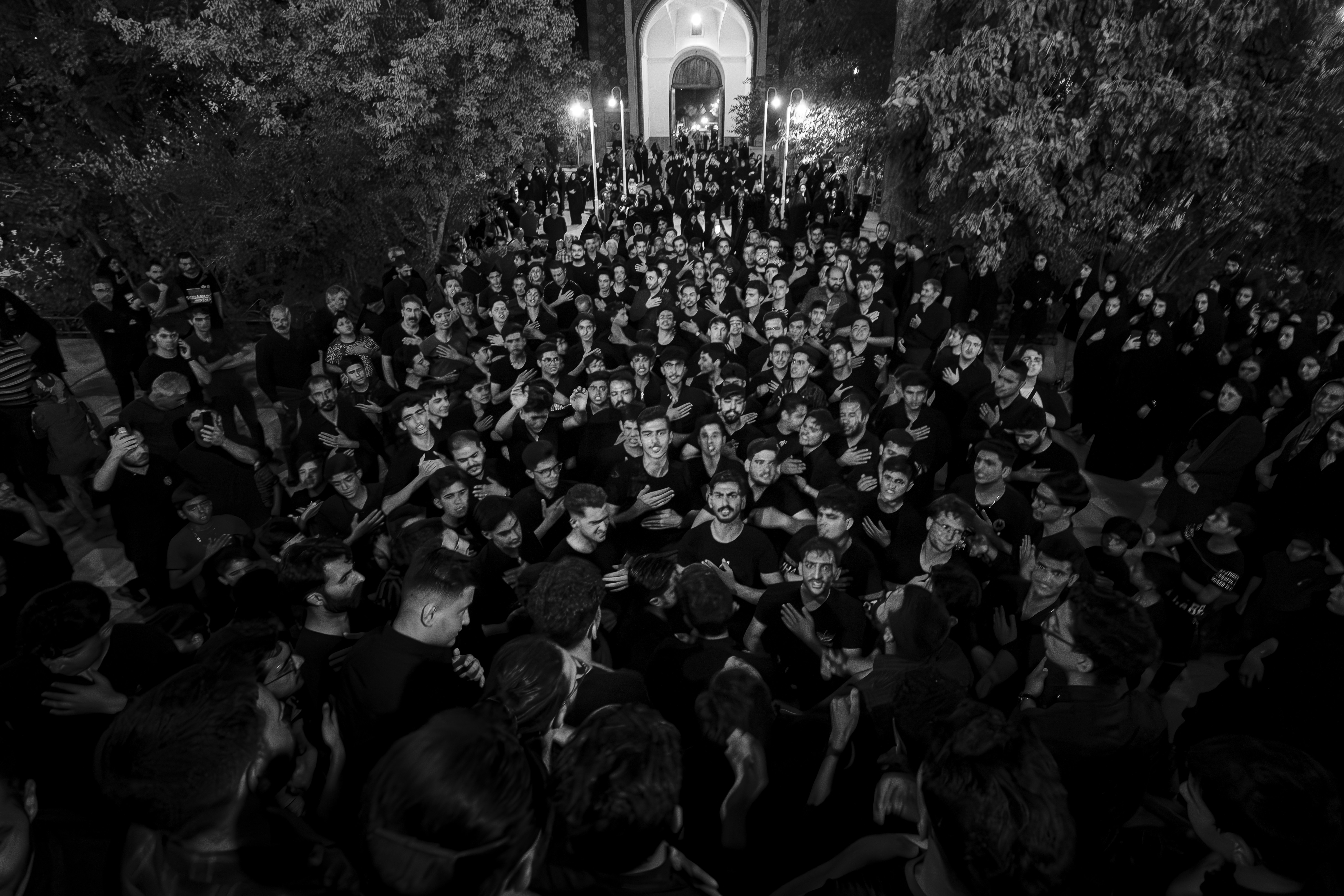 A large group of people standing in front of a building