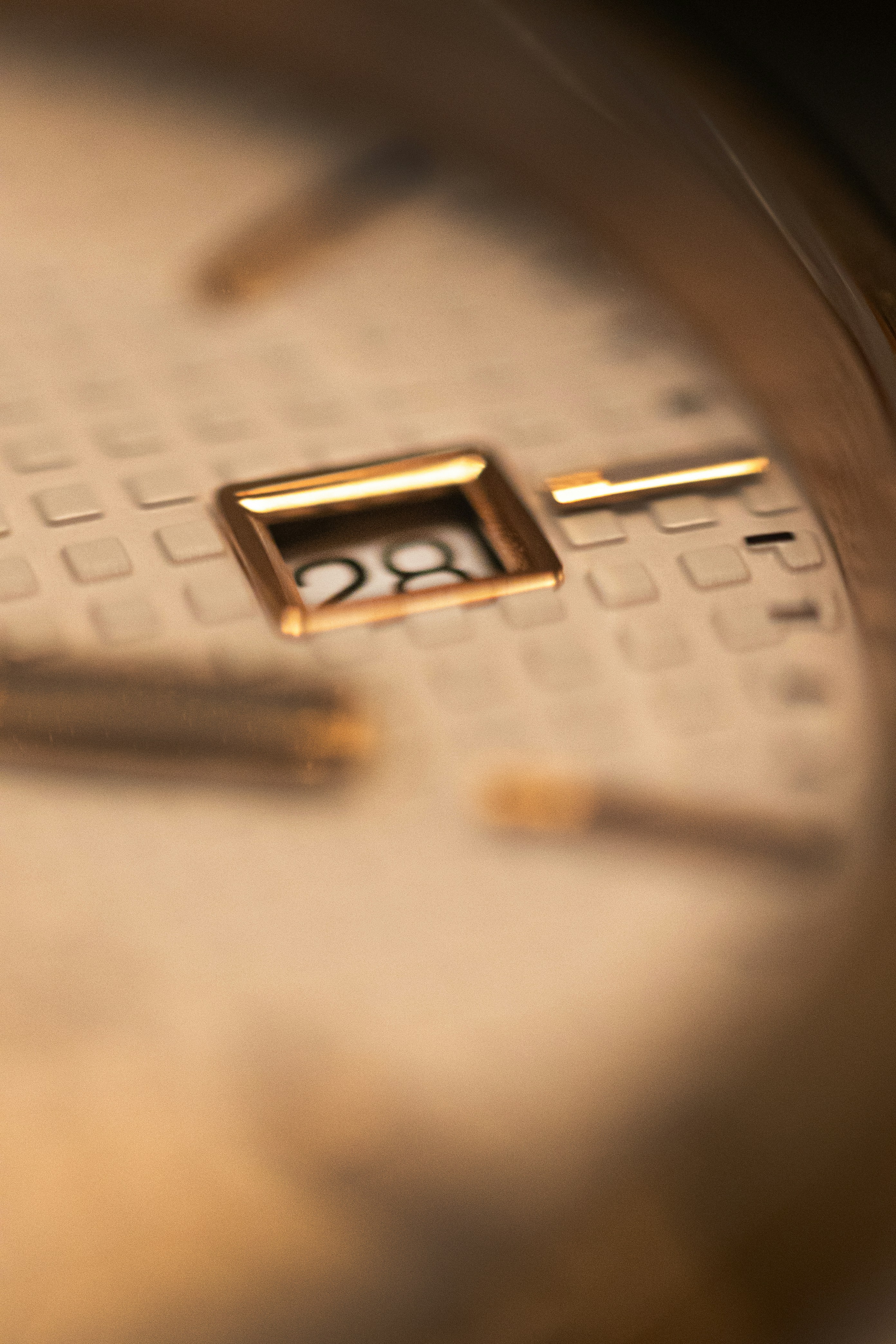 A close up of a gold watch face