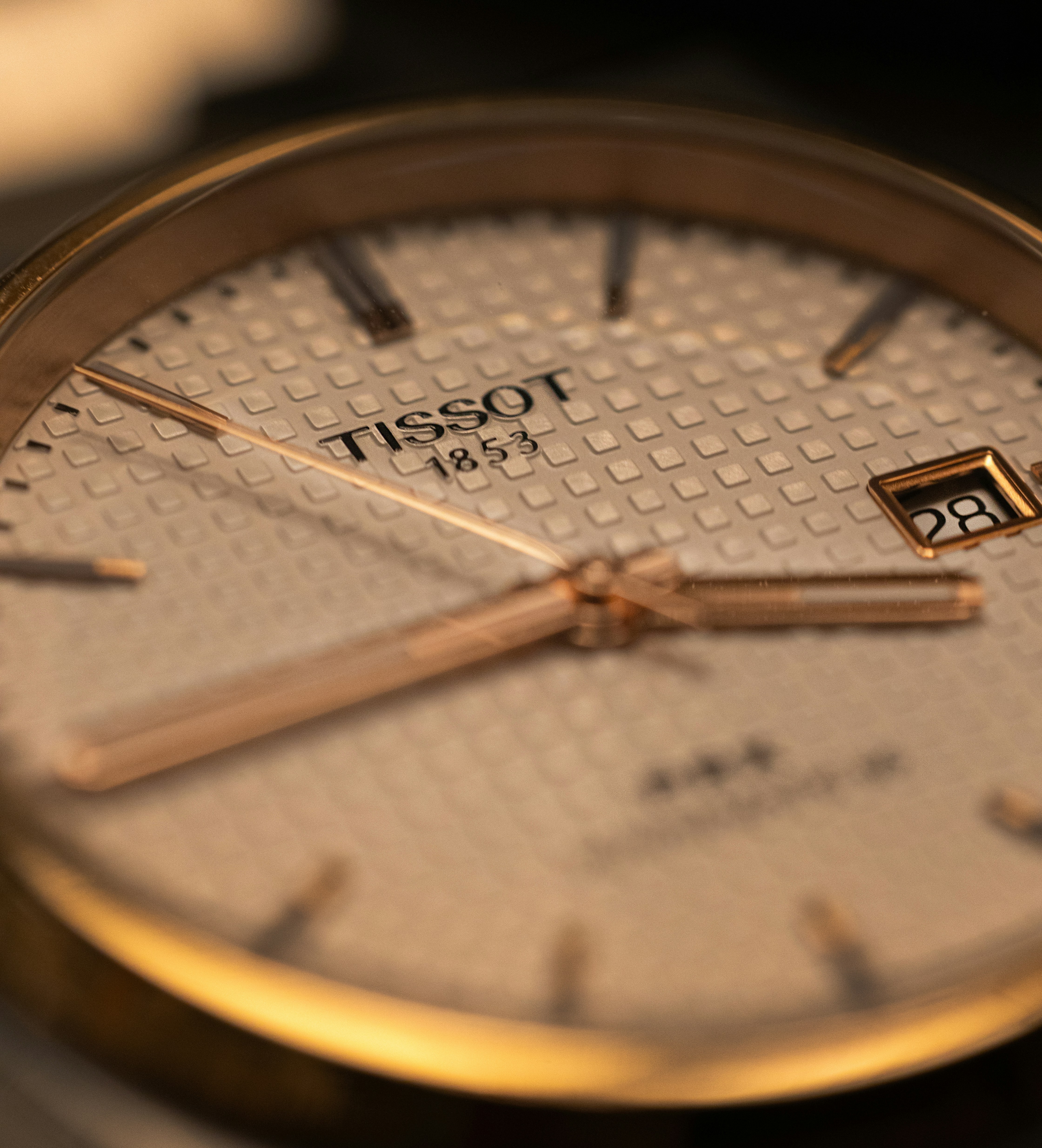 A close up of a gold wrist watch