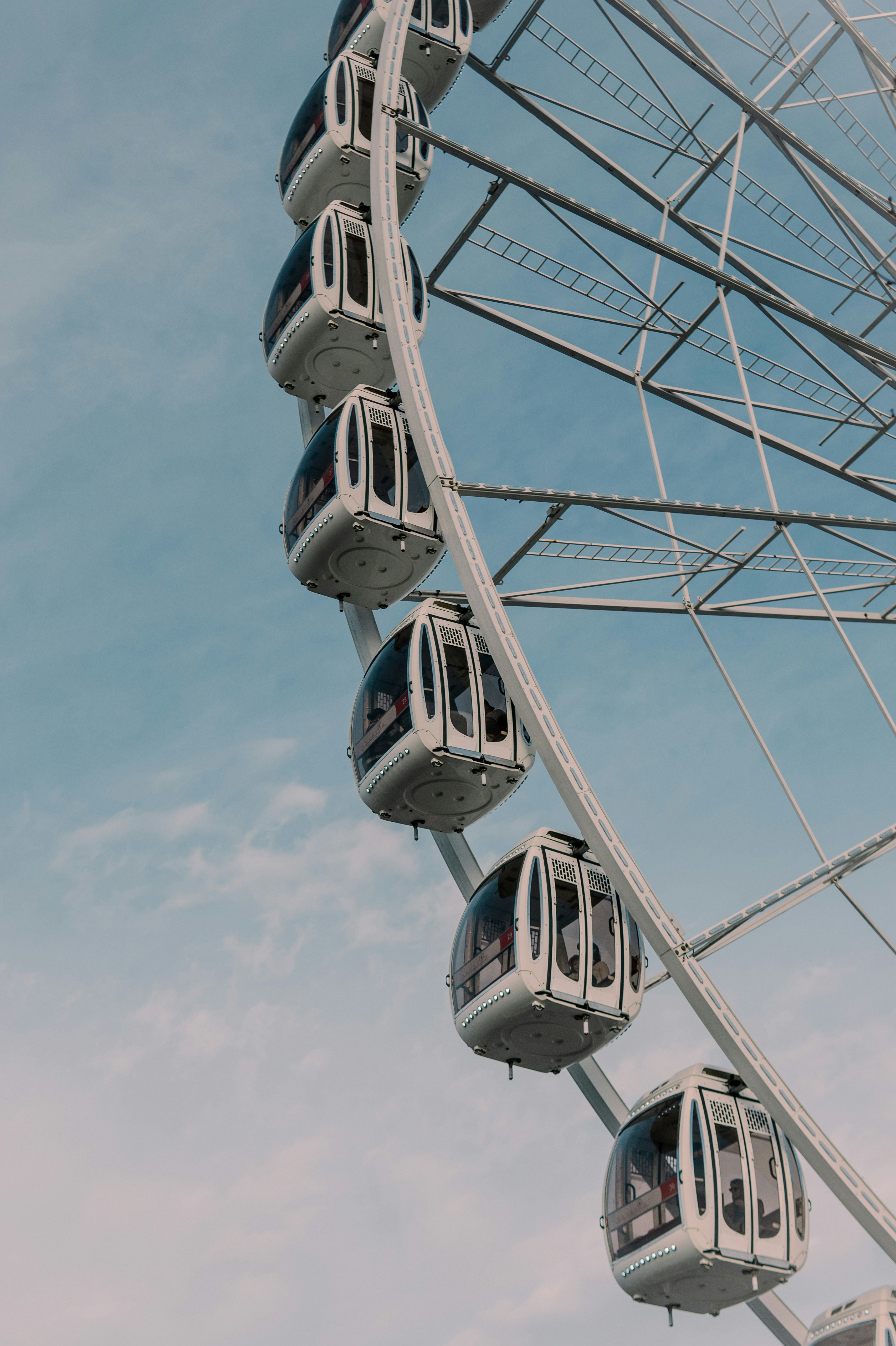 A ferris wheel with people on it against a blue sky