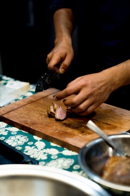A person chopping onions on a cutting board