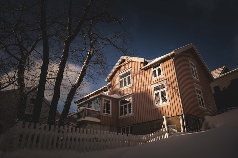White vinyl picket fence in front of a house