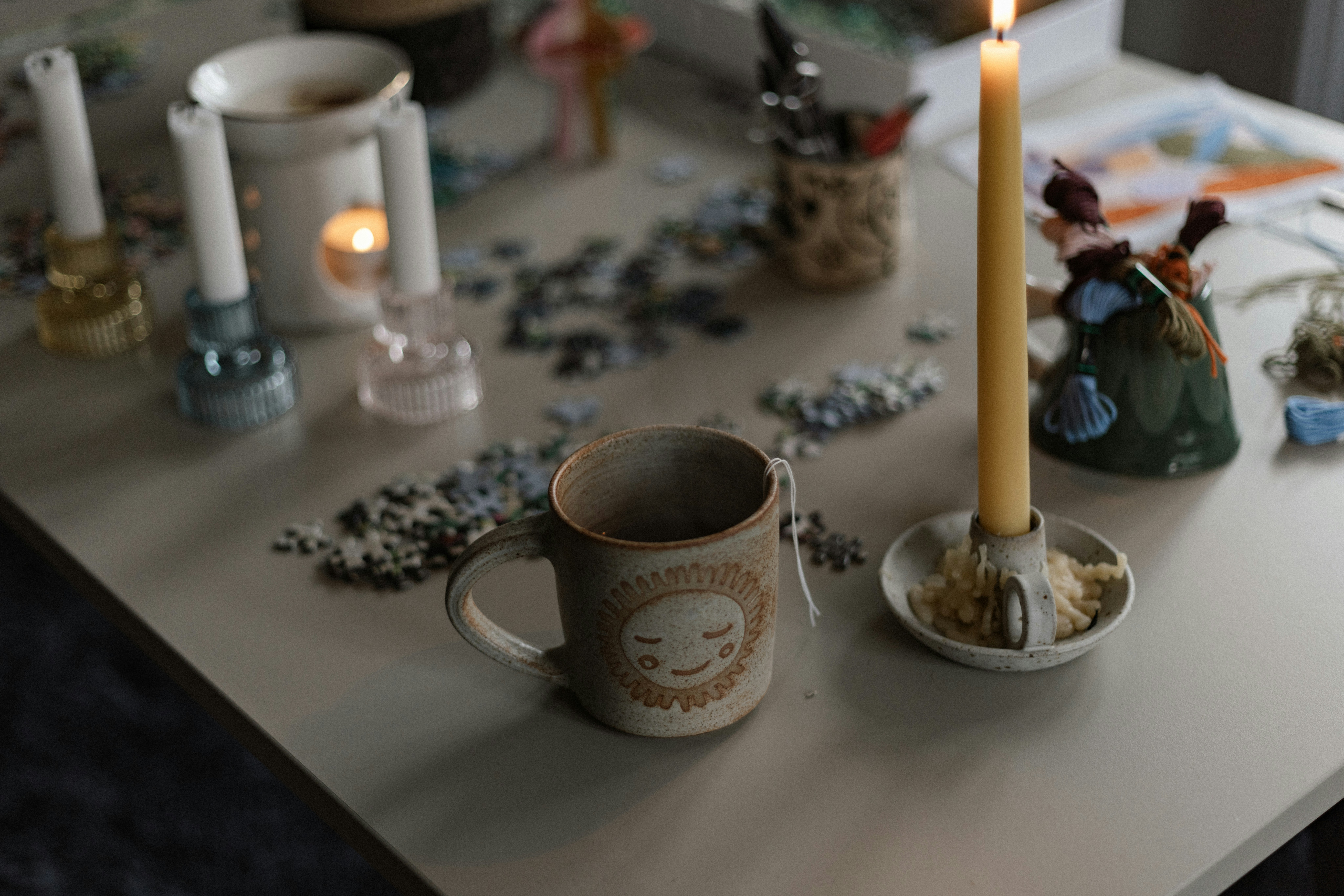 A table topped with candles and other items
