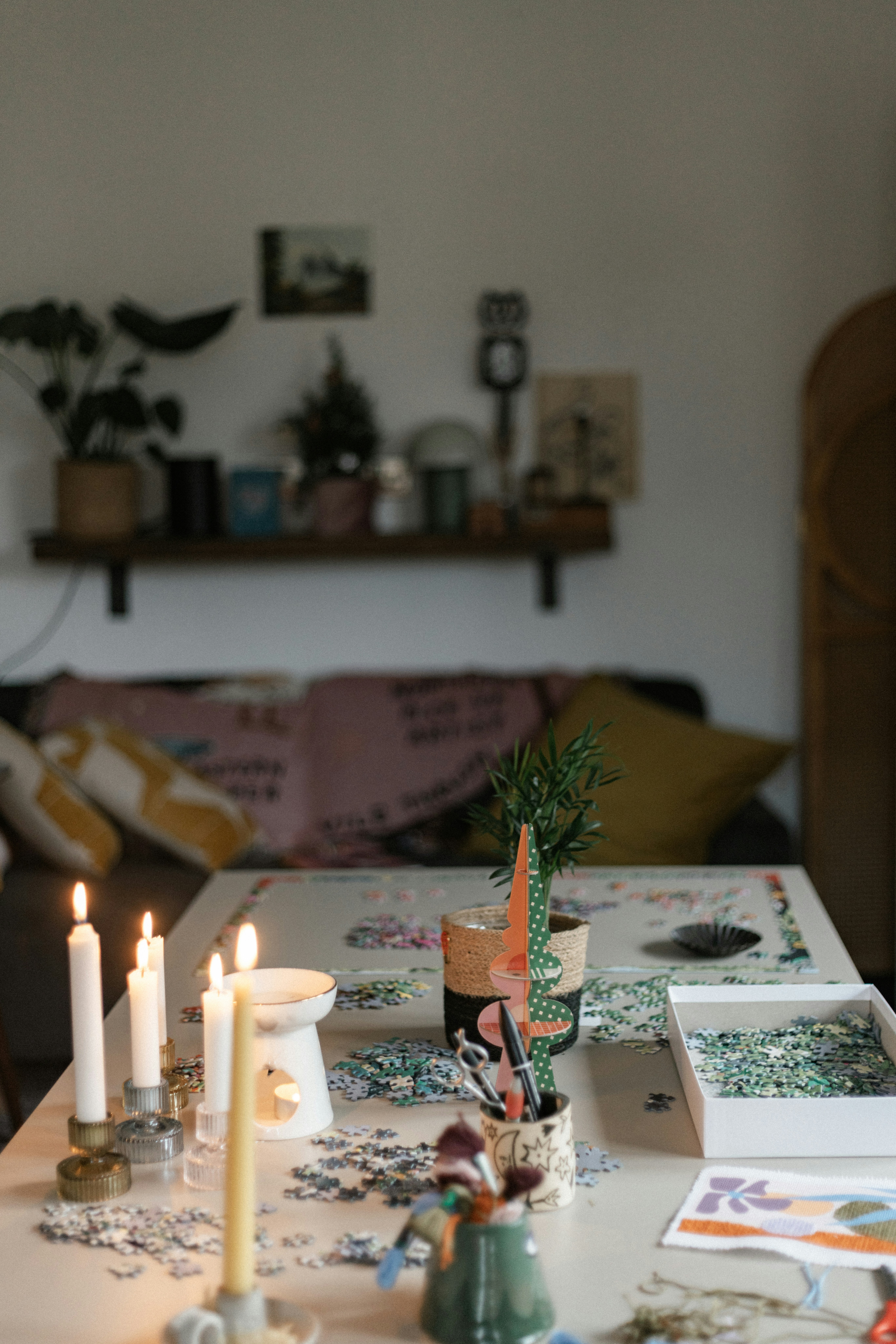 A table with candles and pictures on it