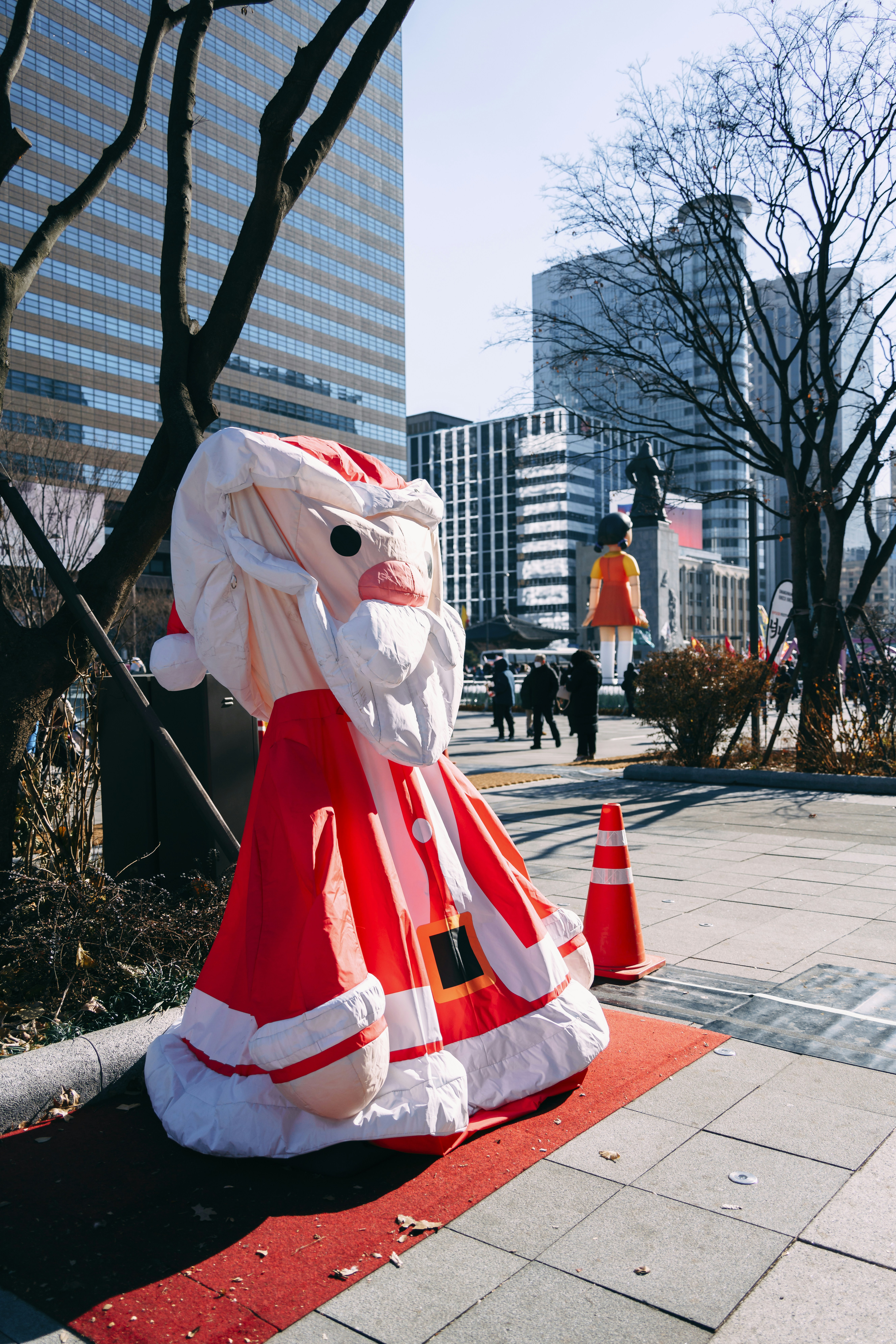 A large inflatable santa clause sitting on top of a red carpet