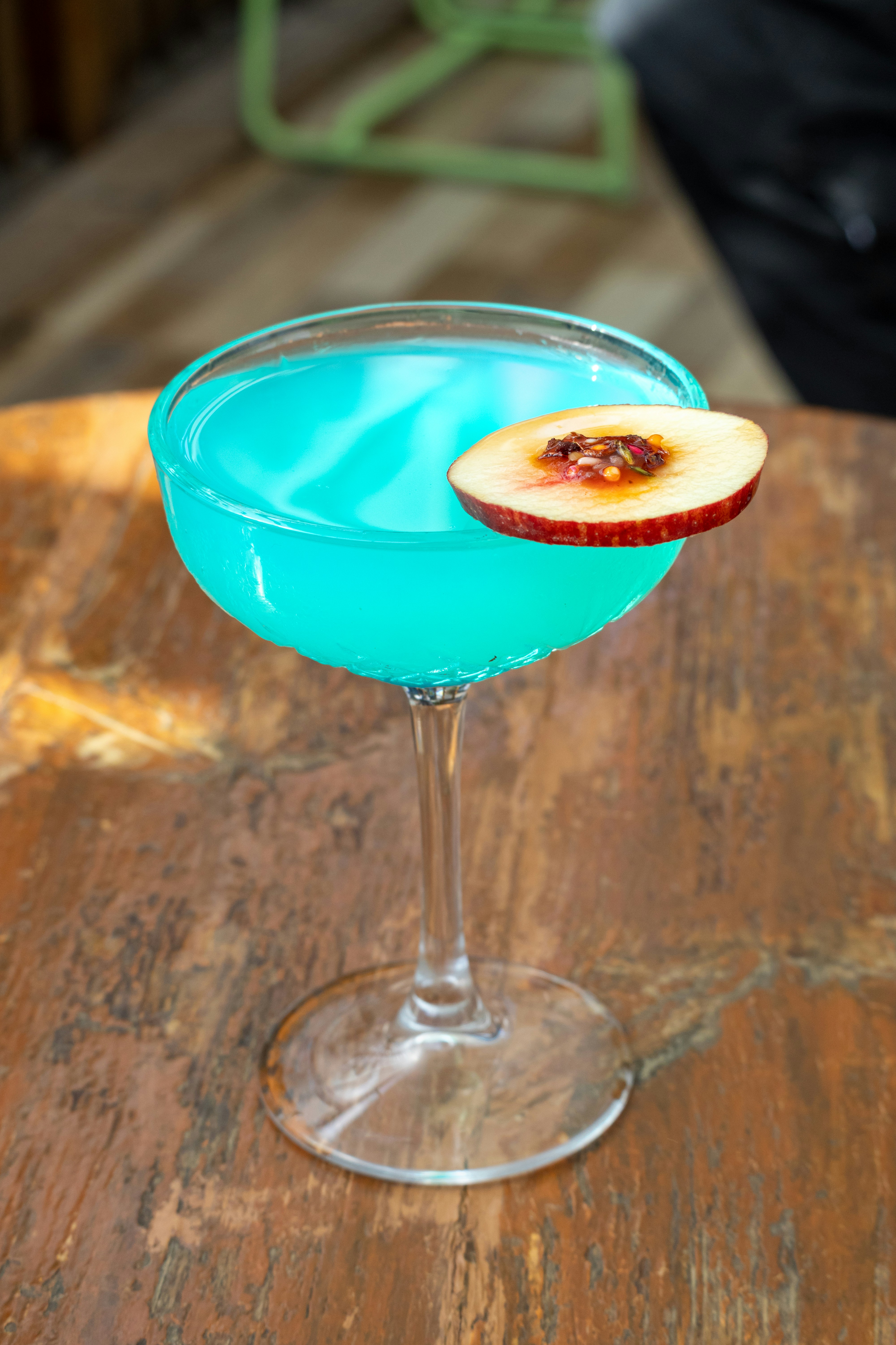 A blue drink sitting on top of a wooden table