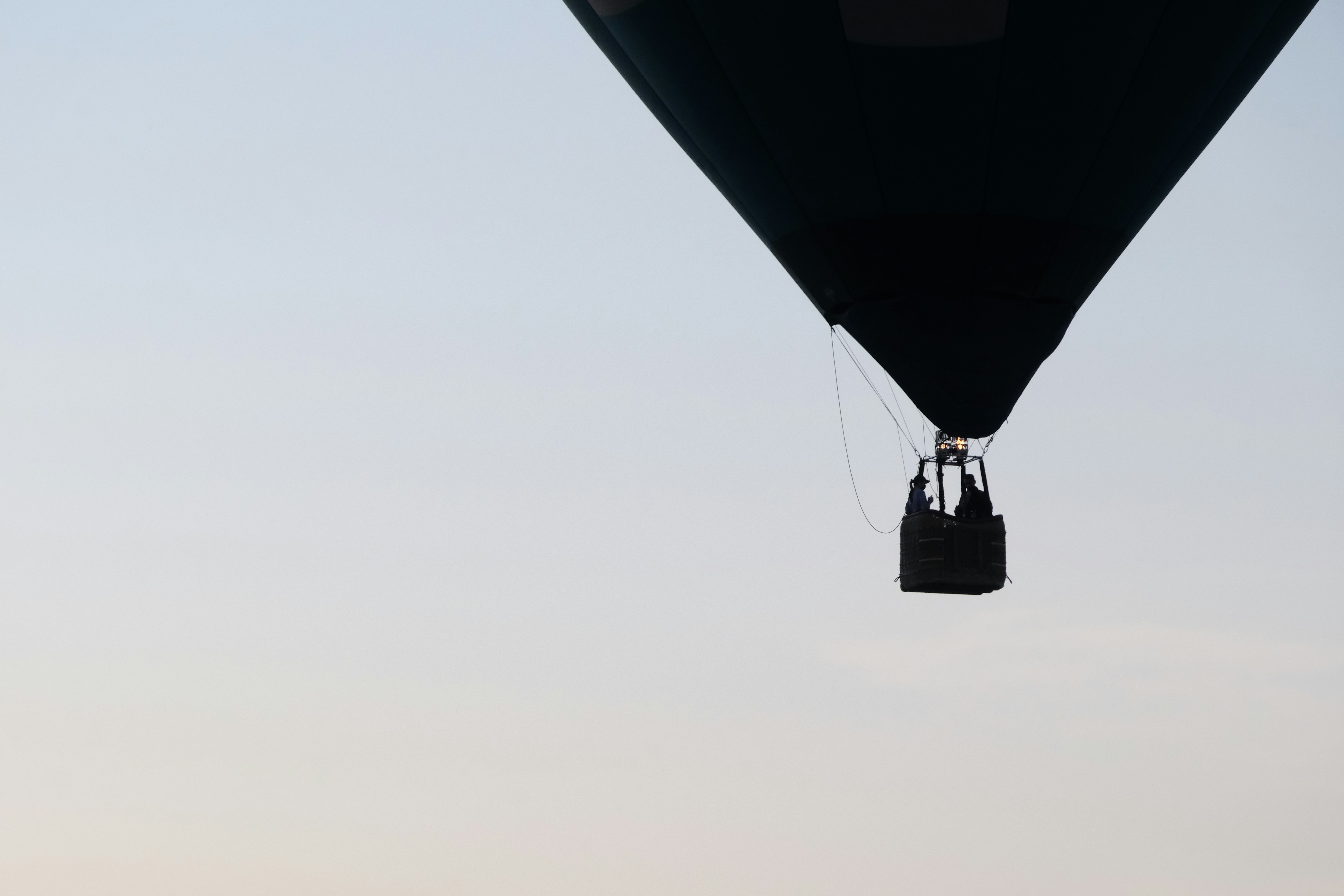 A couple is taking a hot air balloon during sunrise in Chiang Mai, Thailand, for a special and romantic occasion.