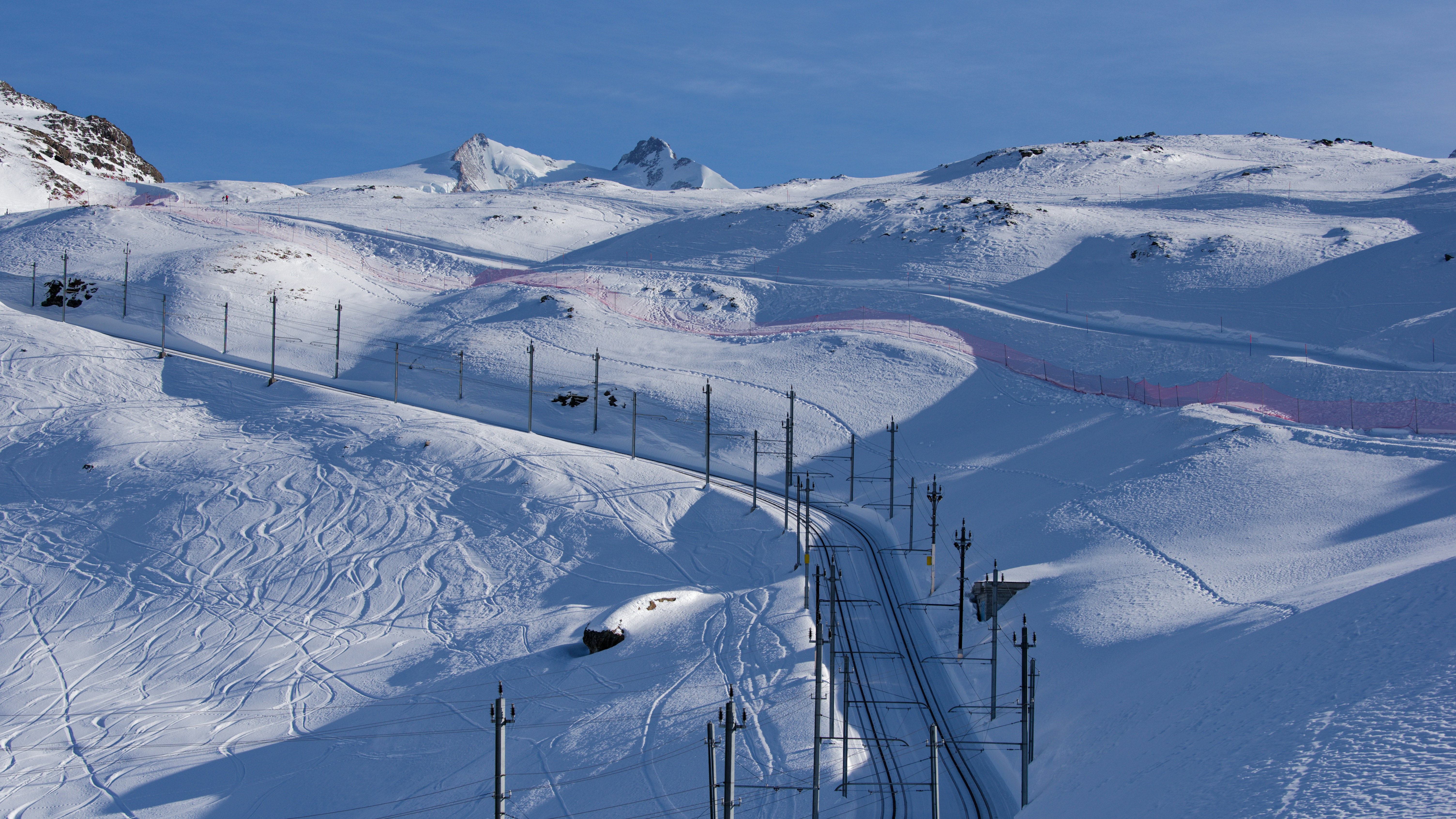 A groomed ski piste high in the Zermatt ski area beneath the peaks