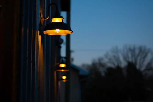 A couple of lights that are on the side of a building