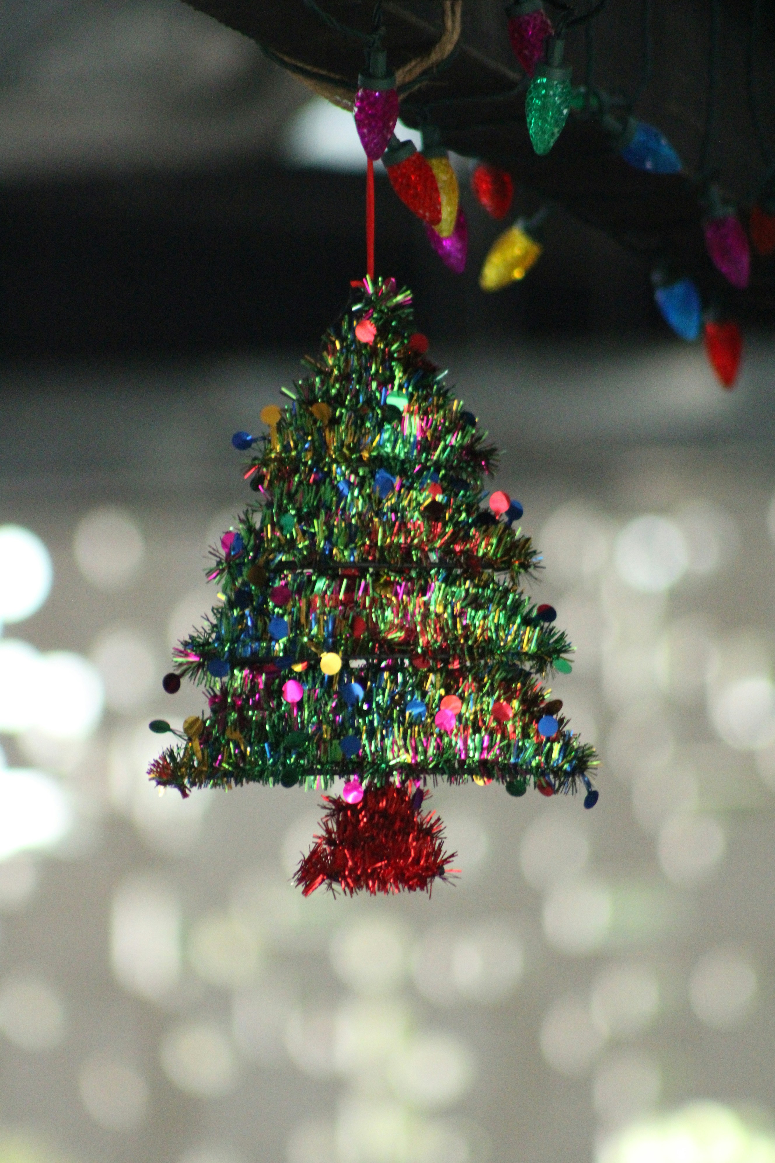 A christmas tree ornament hanging from a ceiling