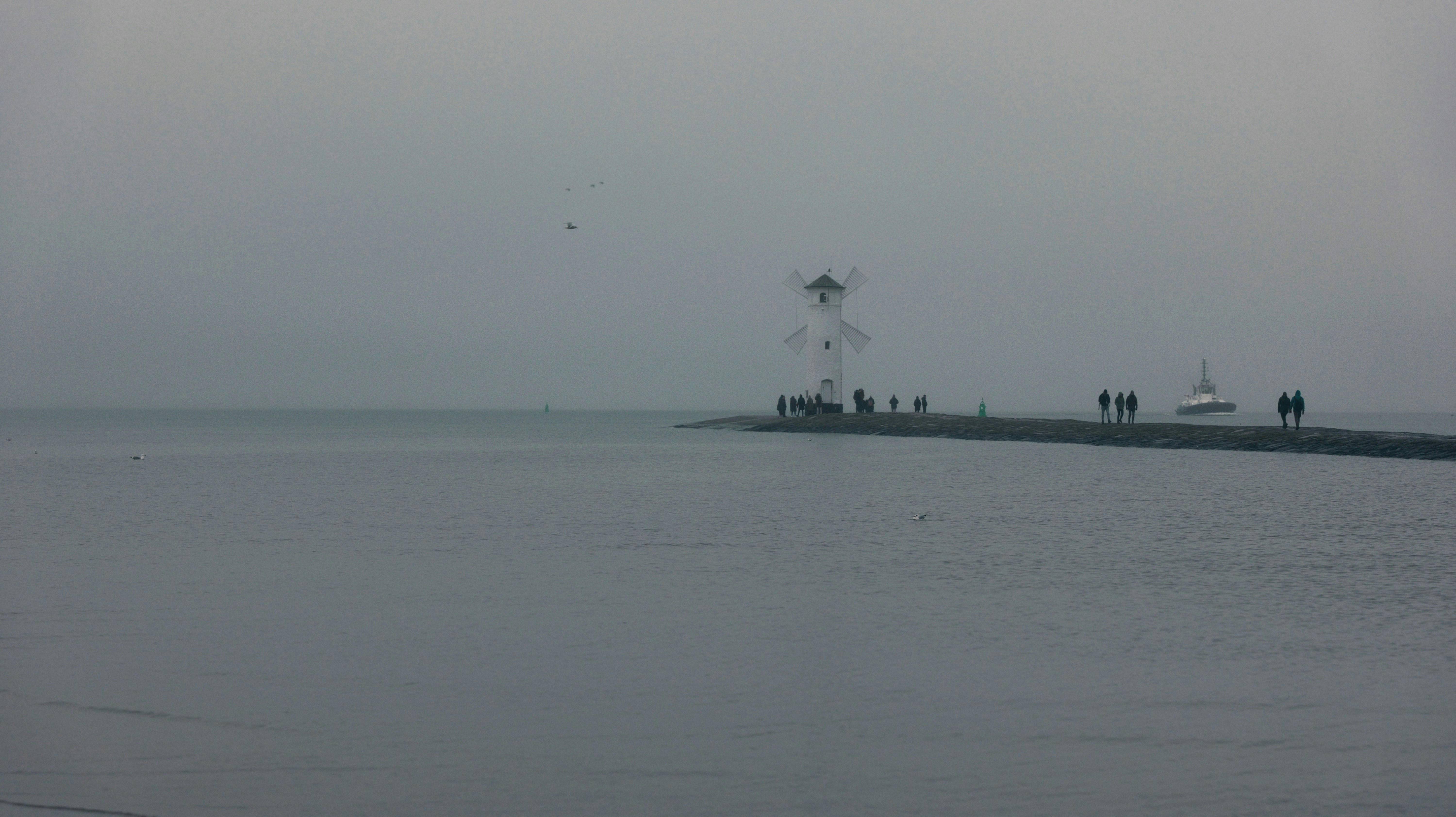 A large body of water with a boat in the distance
