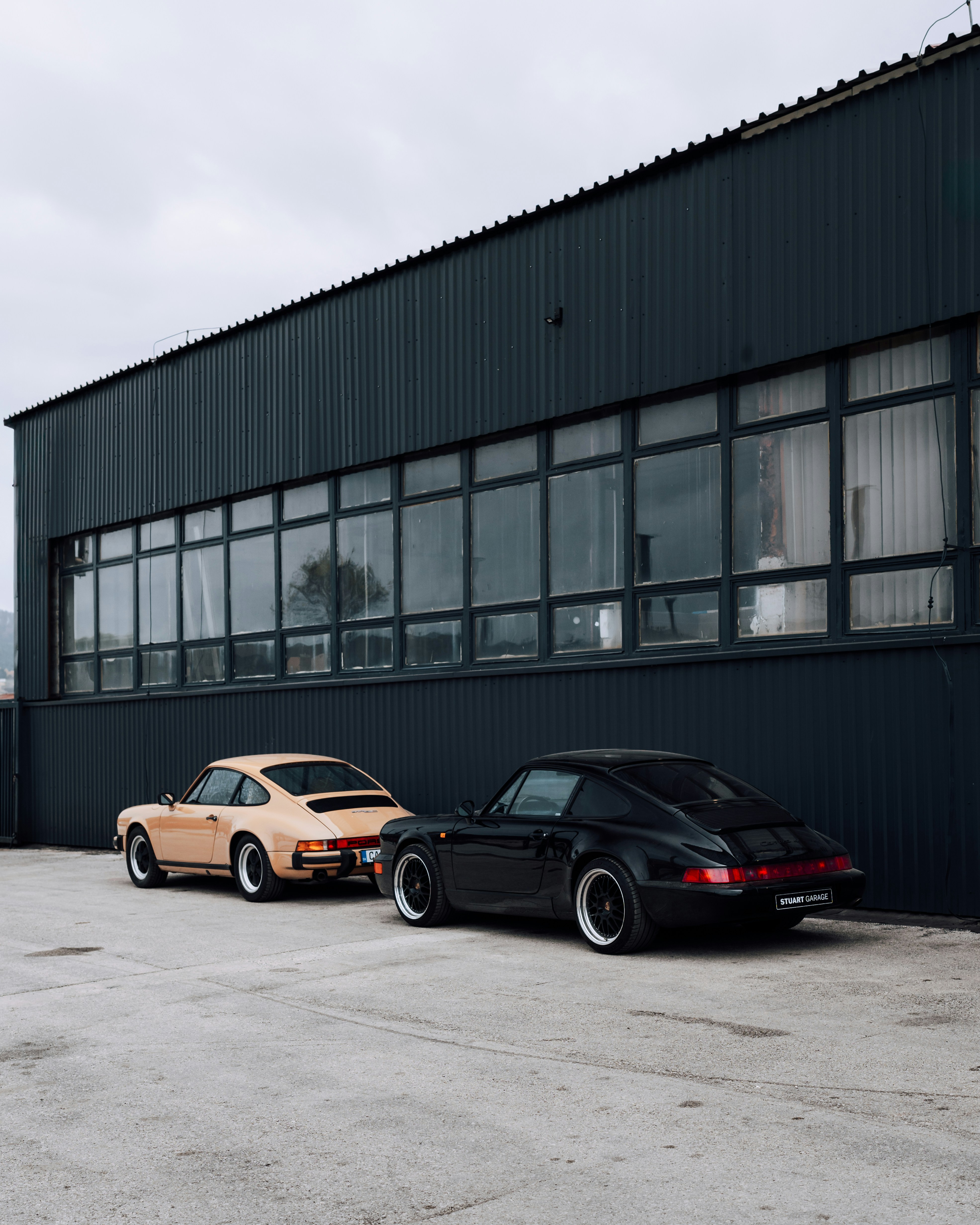A couple of cars parked in front of a building