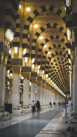A very long hallway with a lot of lights on the ceiling