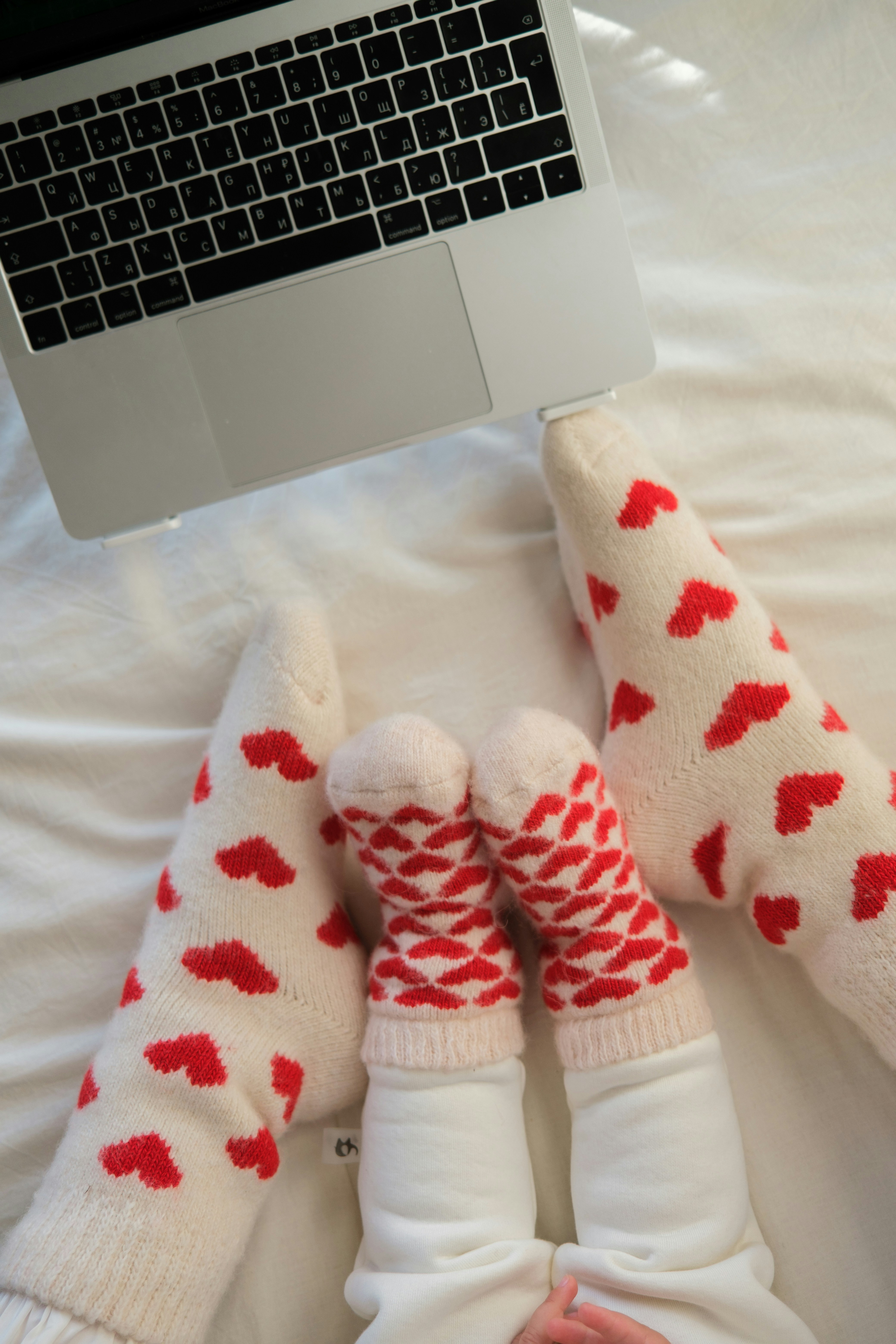 A couple of kids laying on top of a bed