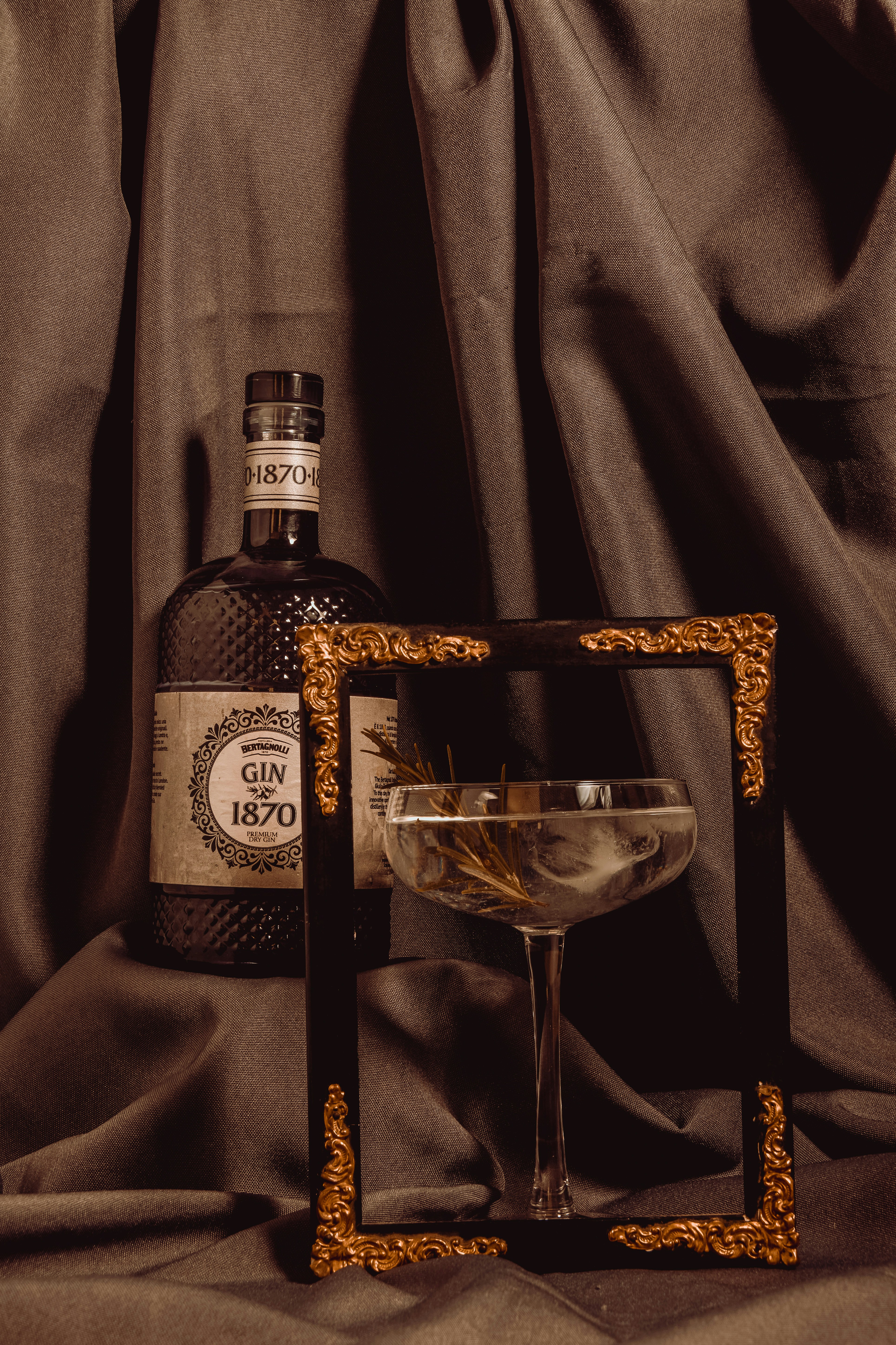 A bottle of alcohol sitting next to a glass