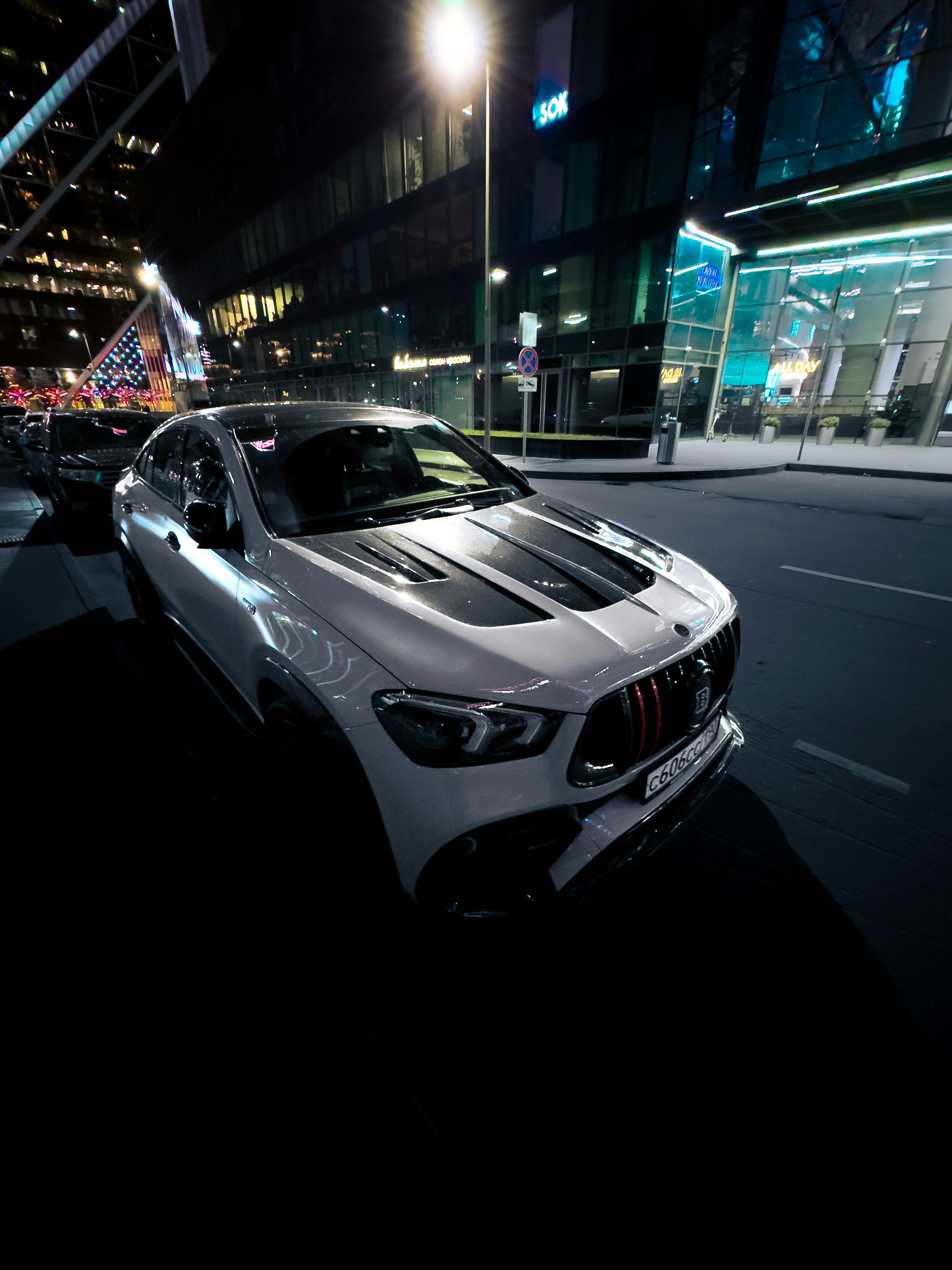 A car driving down a city street at night photo – Free Moscow Image on ...
