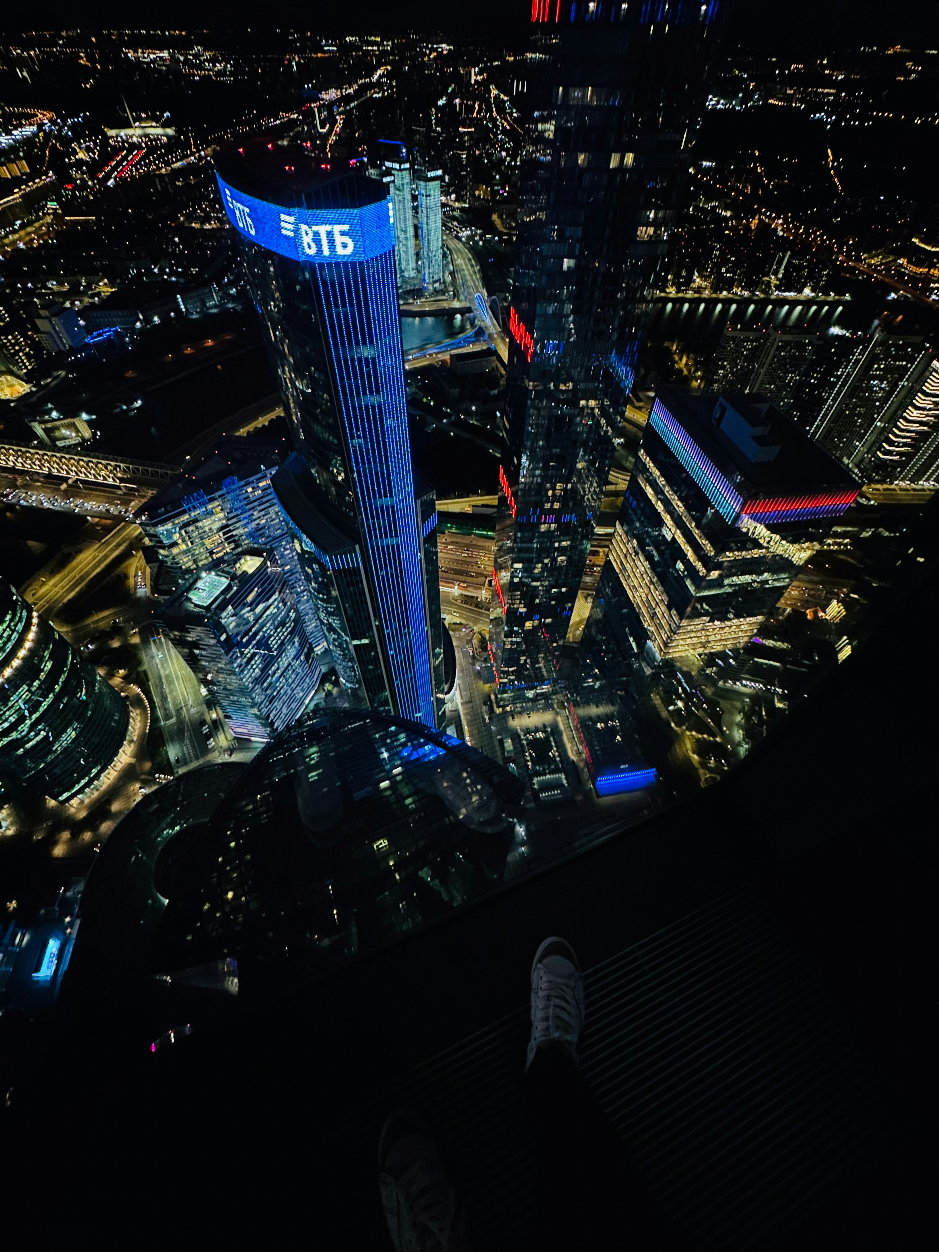 Aerial night view of city skyline with glowing lights