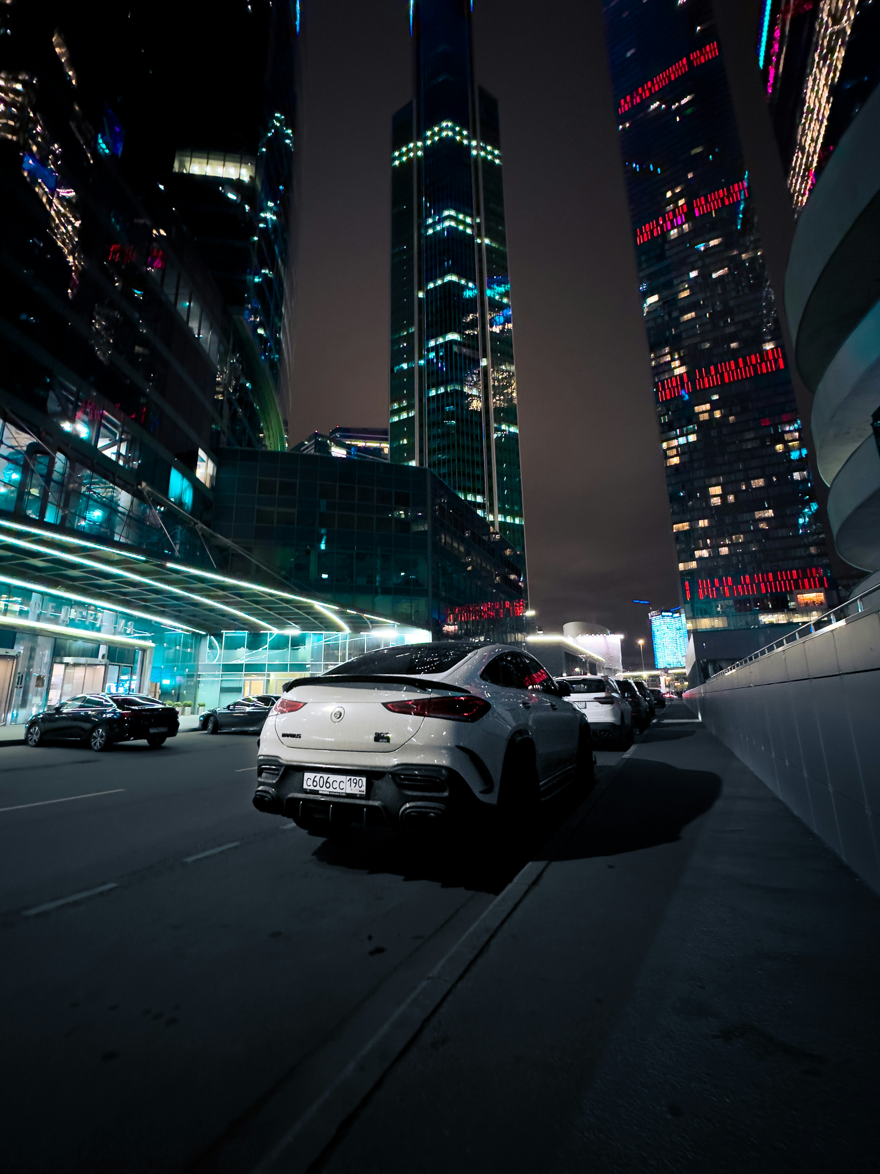 A car driving down a city street at night photo – Free Moscow Image on ...