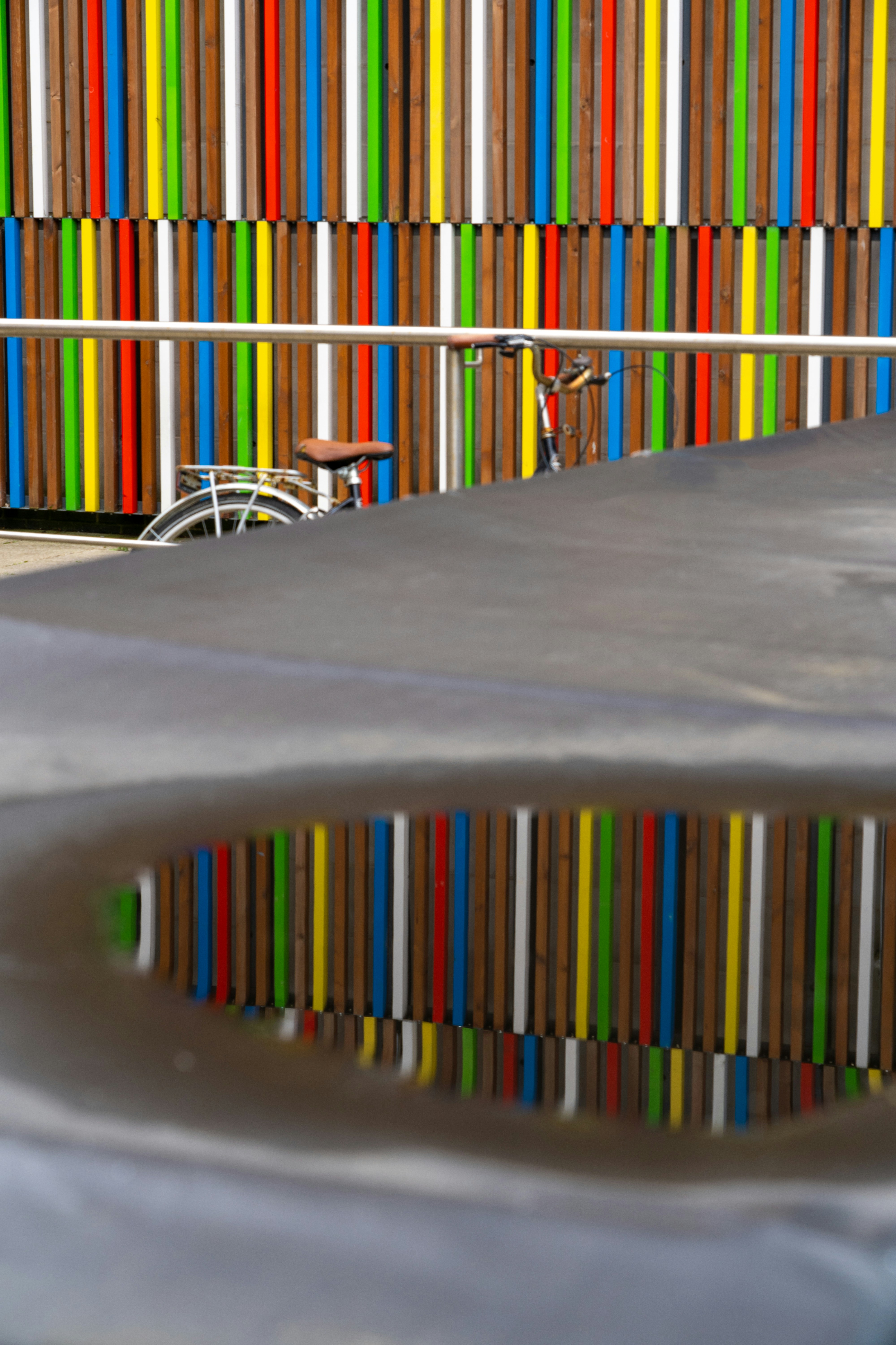 A skateboarder is doing a trick in a pool of water