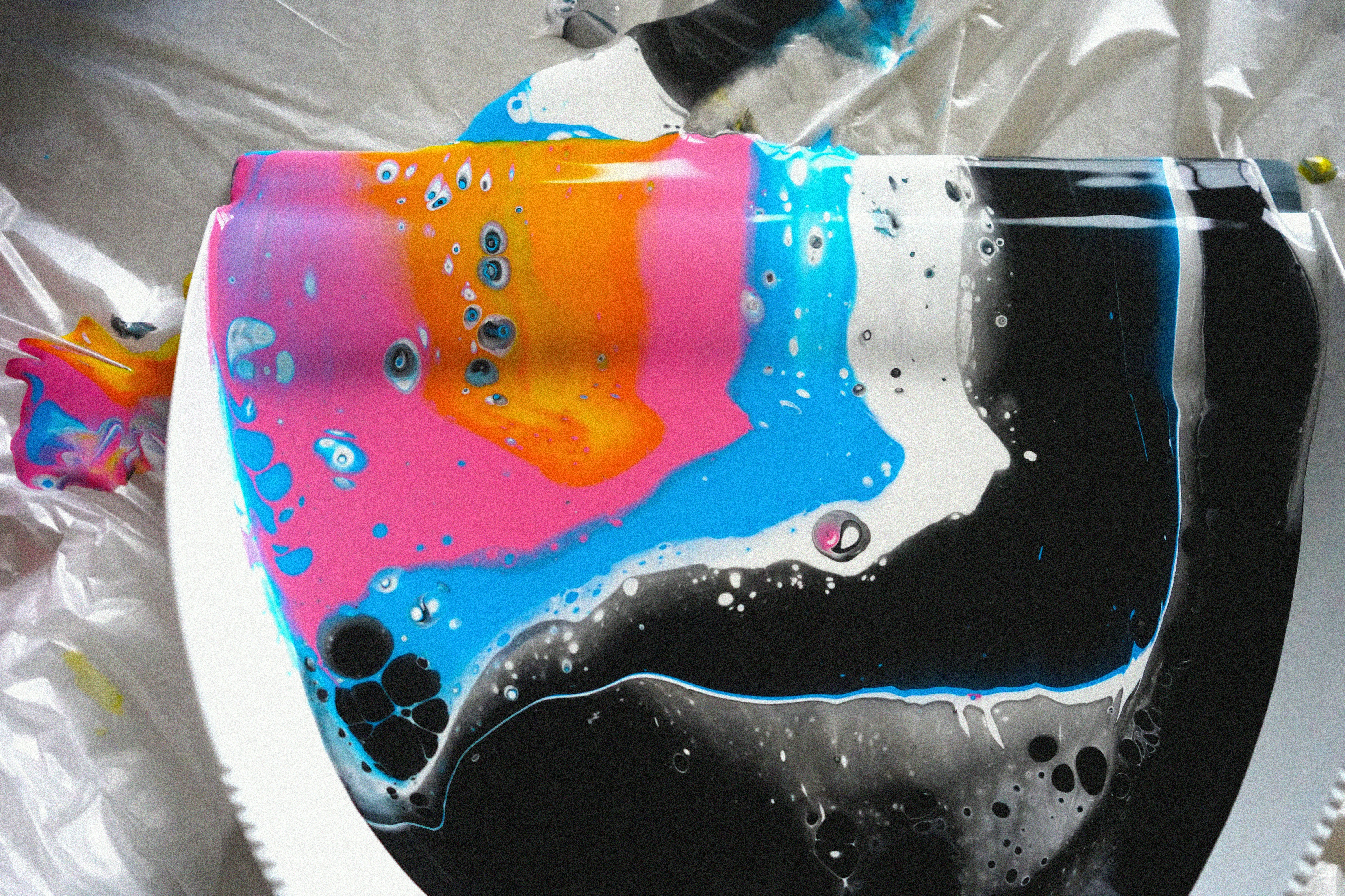 A toilet covered in a plastic bag with a colorful design on it